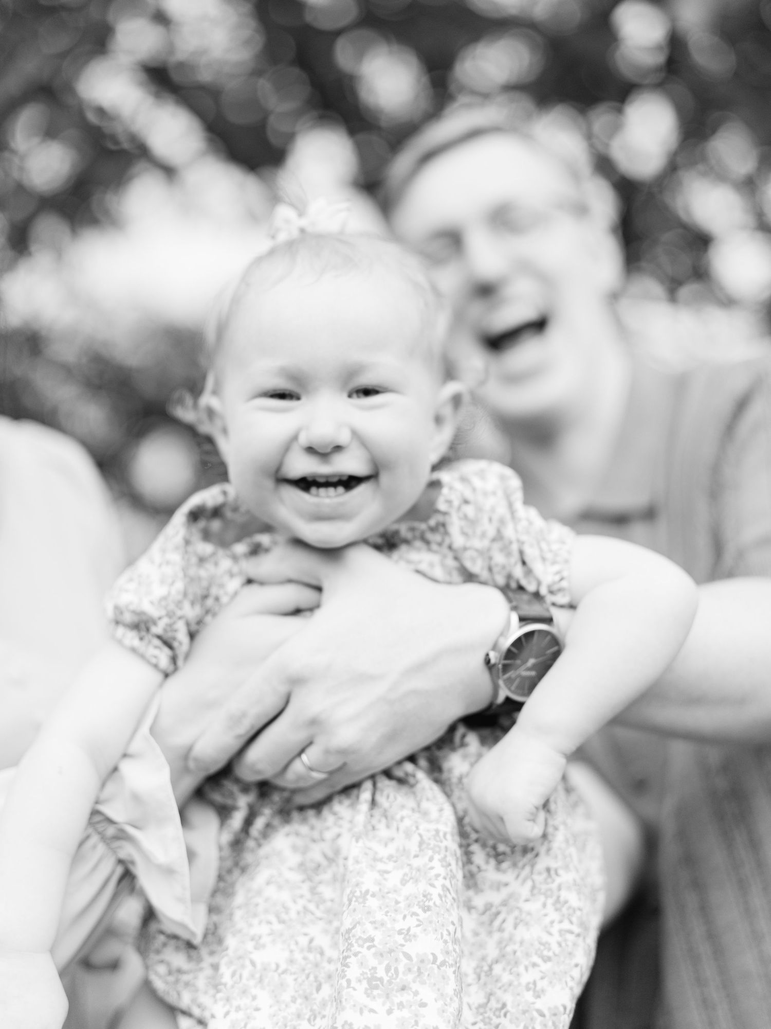 Black and white close-up shots capture joyful expressions and laughter in an outdoor setting.
