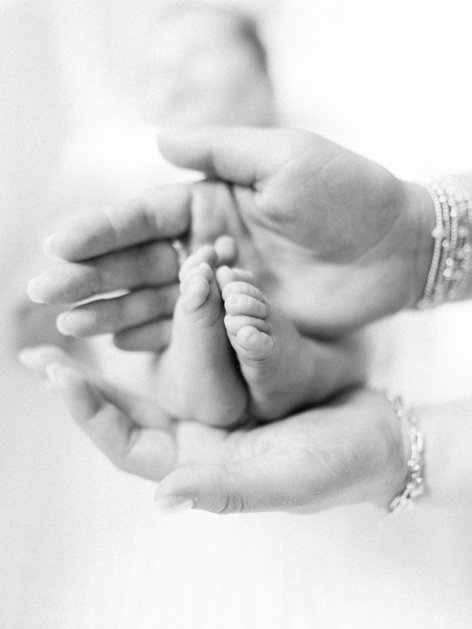 A series of black and white close-up photos showing hands holding each other in different tender gestures.