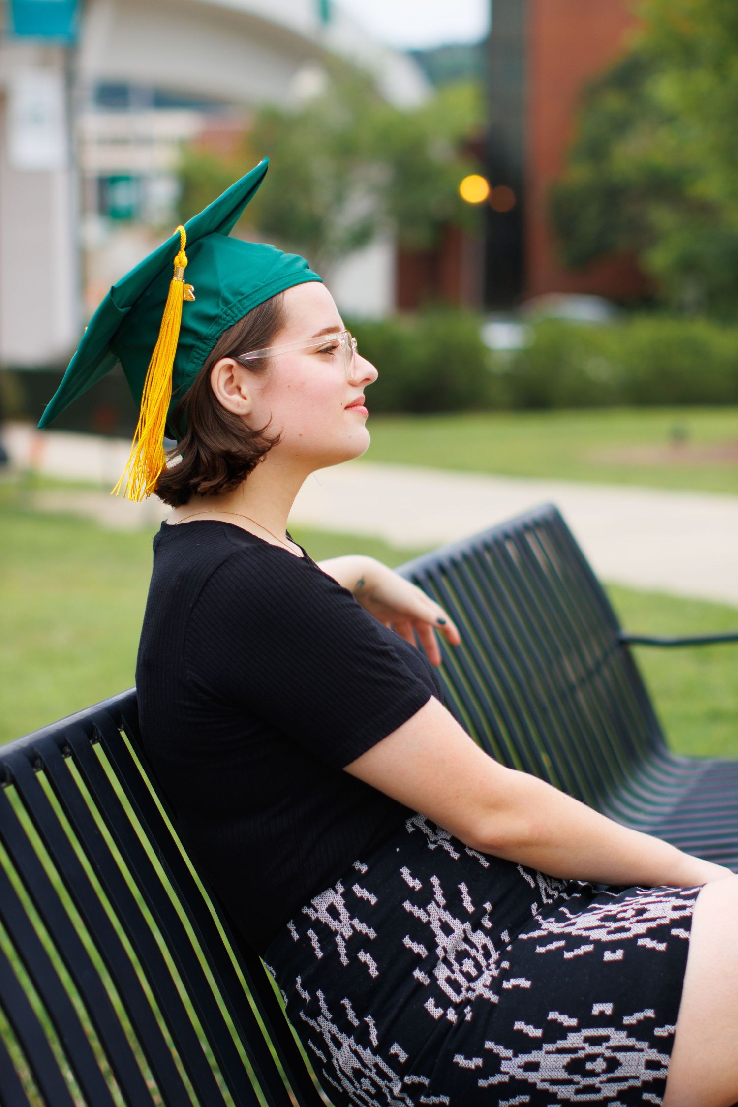 Graduate posing in cap and gown during a UAB graduation photoshoot.