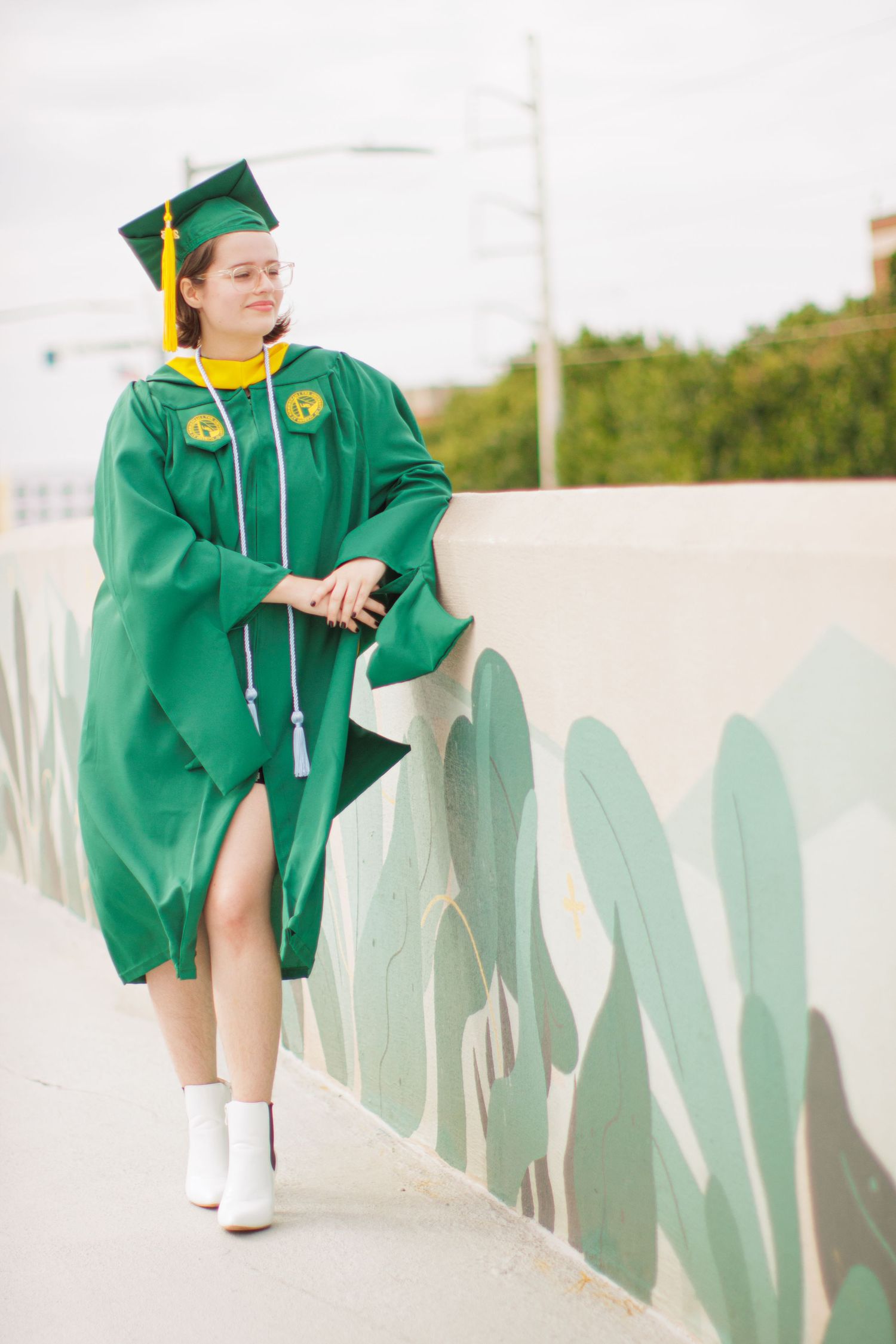 Graduate posing in cap and gown during a UAB graduation photoshoot.