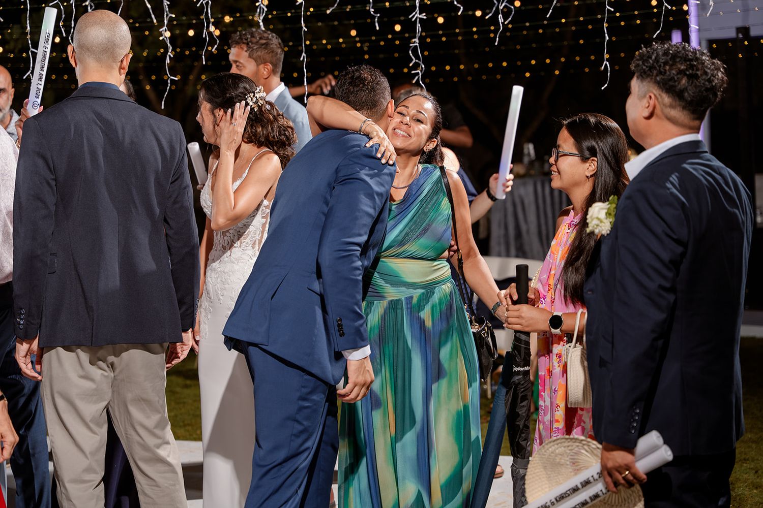 A crowd of well-dressed guests mingle at an elegant social gathering or celebration event.