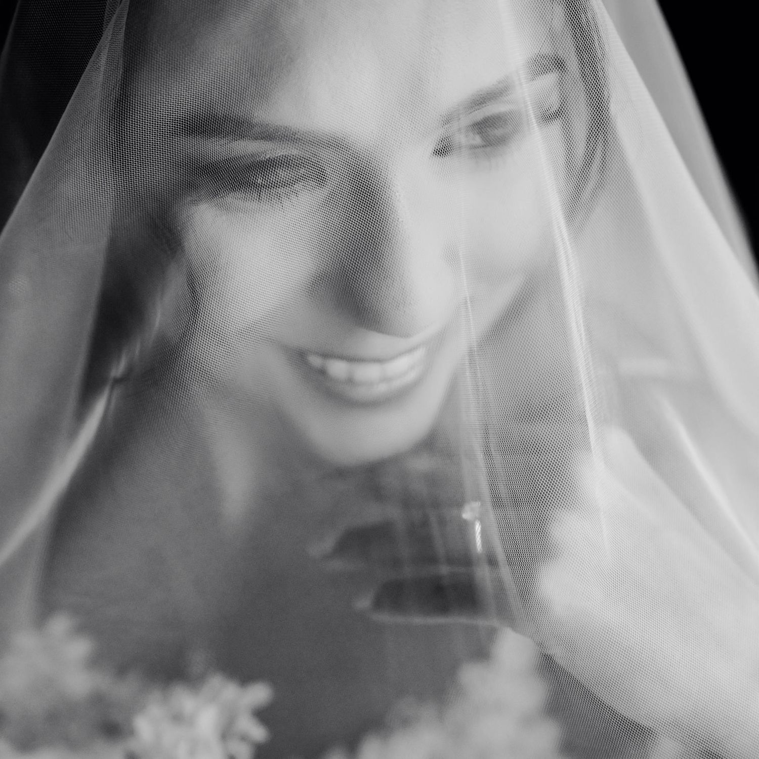 Black and white artistic photo sequence showing close up expressions under a flowing white veil or fabric.