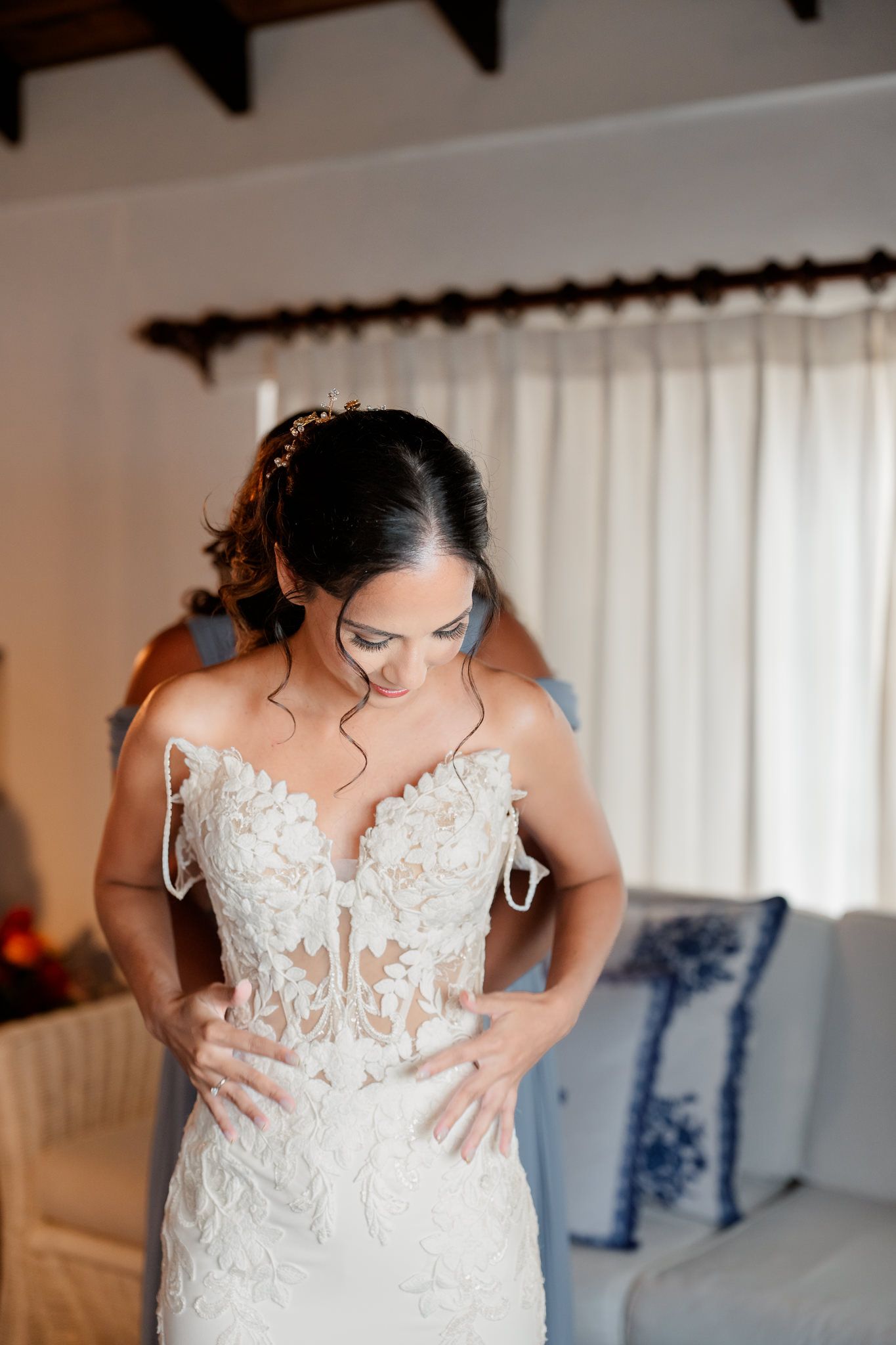A stunning white lace wedding gown with intricate floral appliques and sheer details accentuates an elegant silhouette.