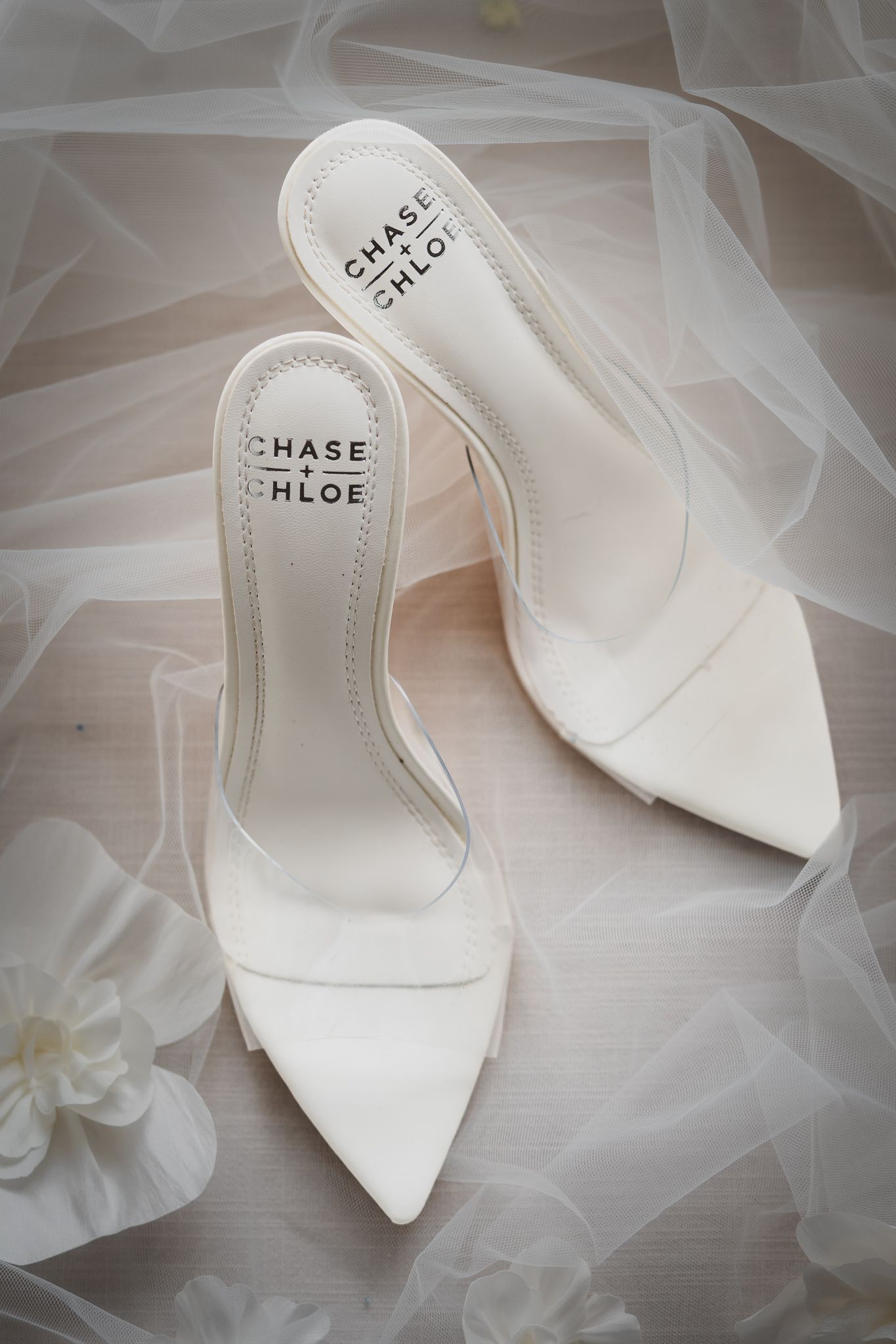 White Chase & Chloe pointed-toe slingback heels on a soft tulle veil with delicate floral accents.