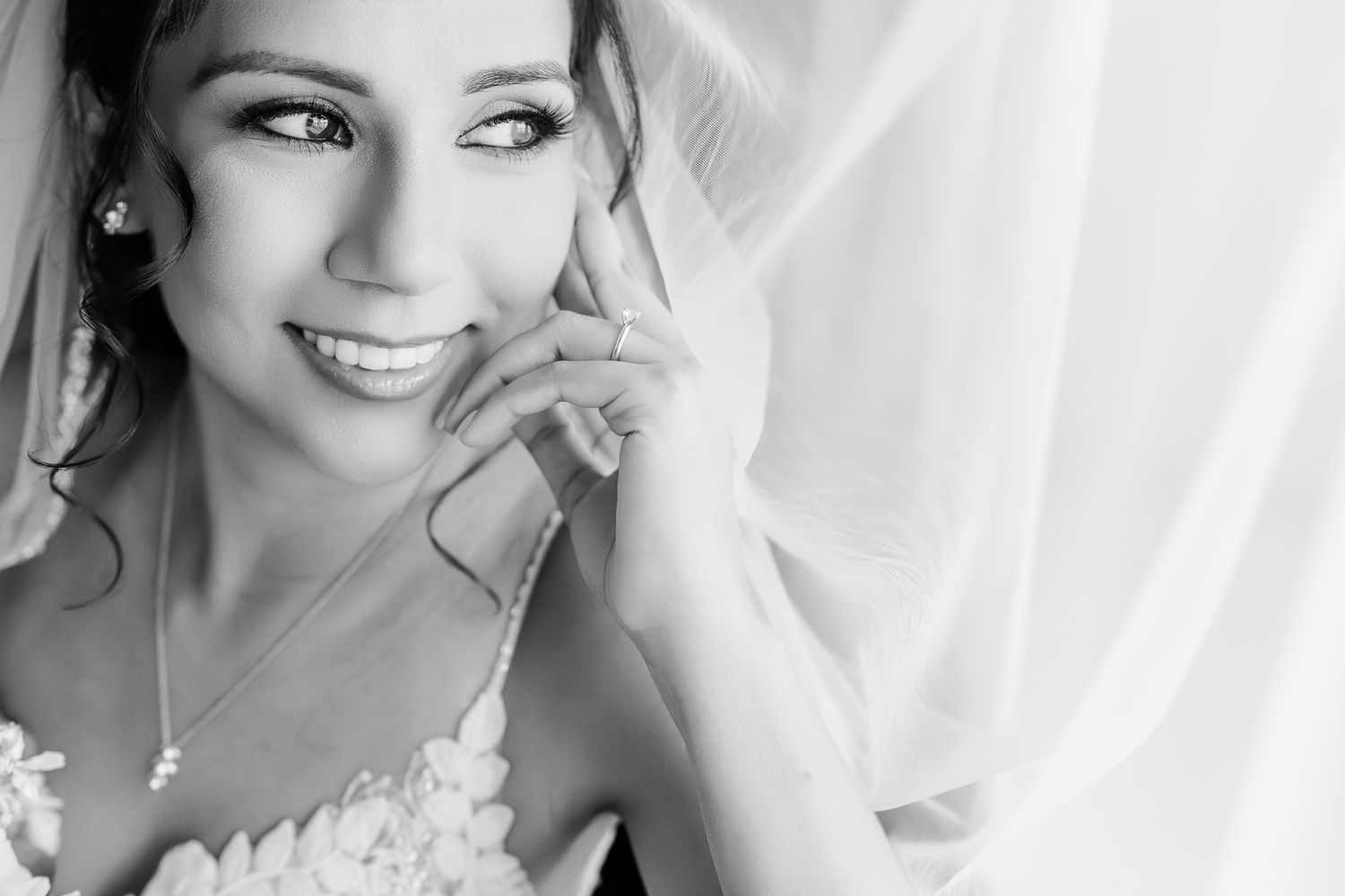 Black and white close-up portrait showing soft, natural expressions with delicate side lighting.