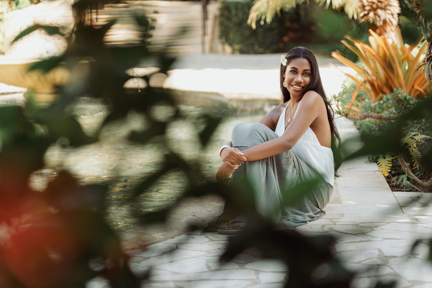 Tropical wedding venue with lush palm fronds and greenery creating a natural, romantic atmosphere.