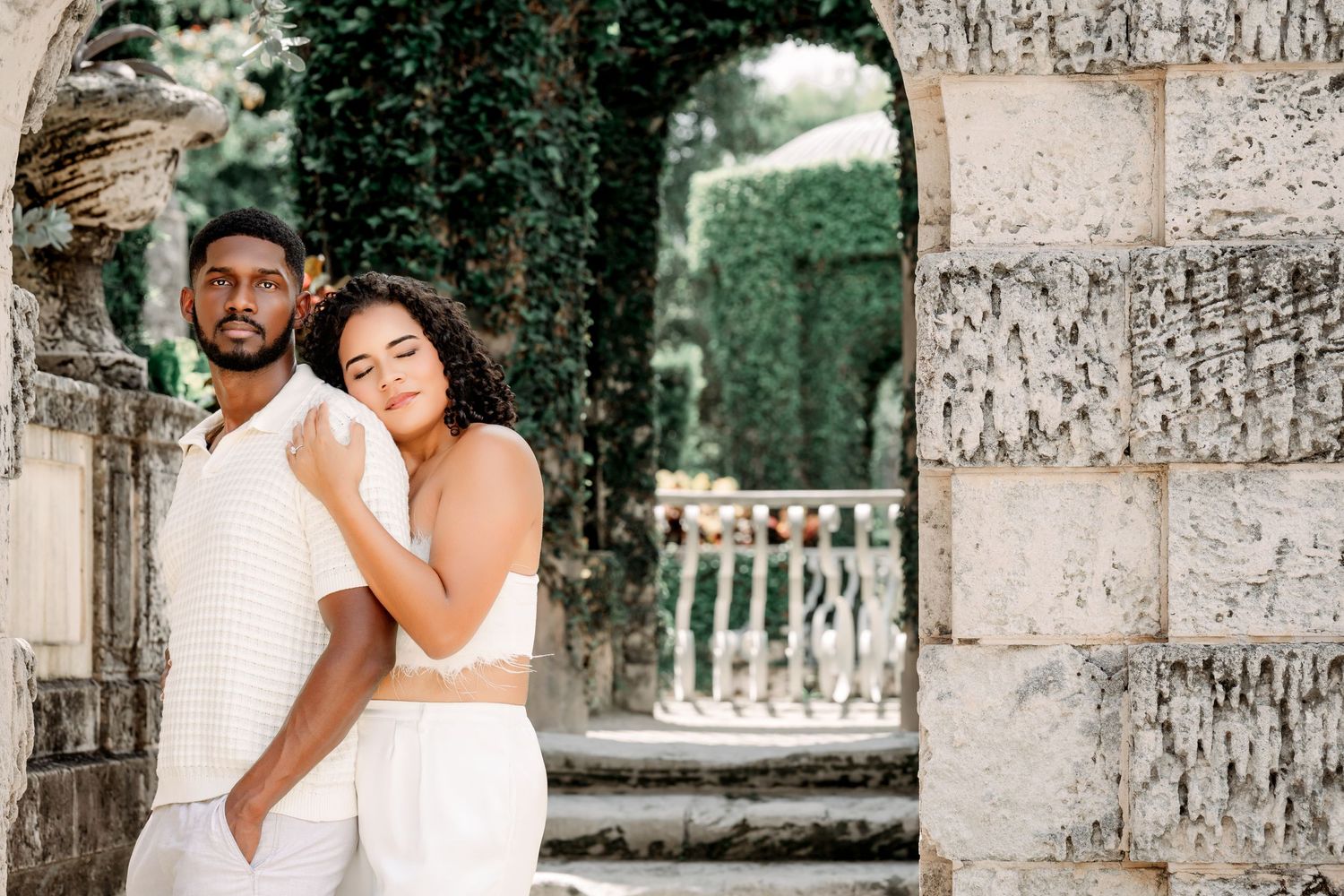 A romantic wedding photo collage showing tender moments between a couple among stone columns and palm trees.