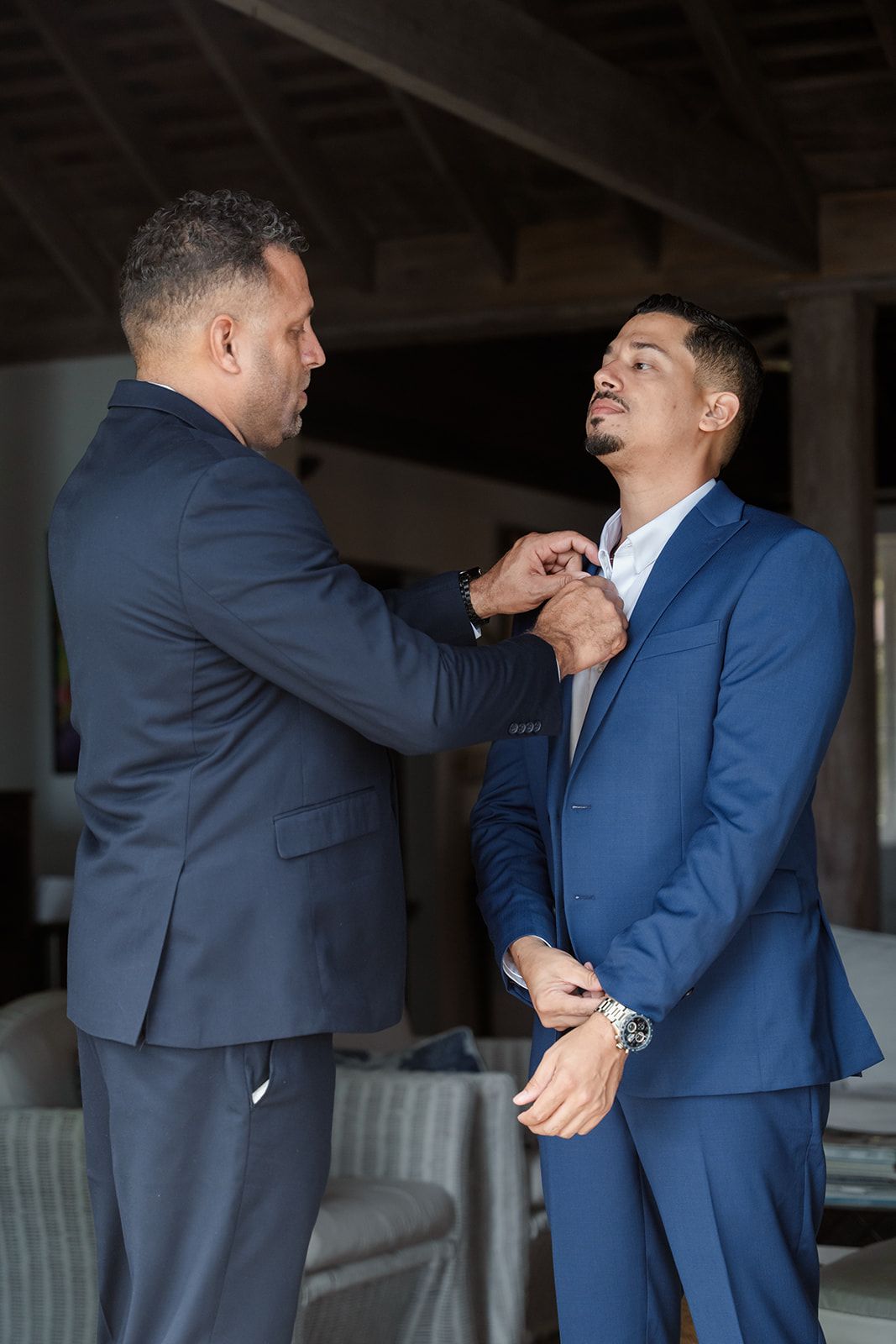 Two men in blue suits engage in what appears to be a physical altercation or aggressive interaction.