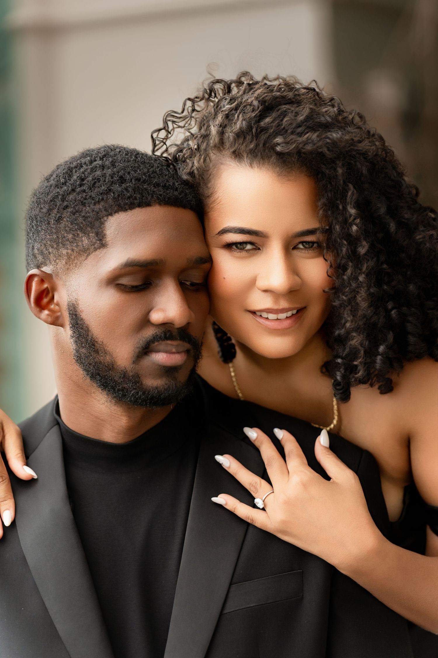 A romantic couple in black attire share intimate moments across a series of connected photos.