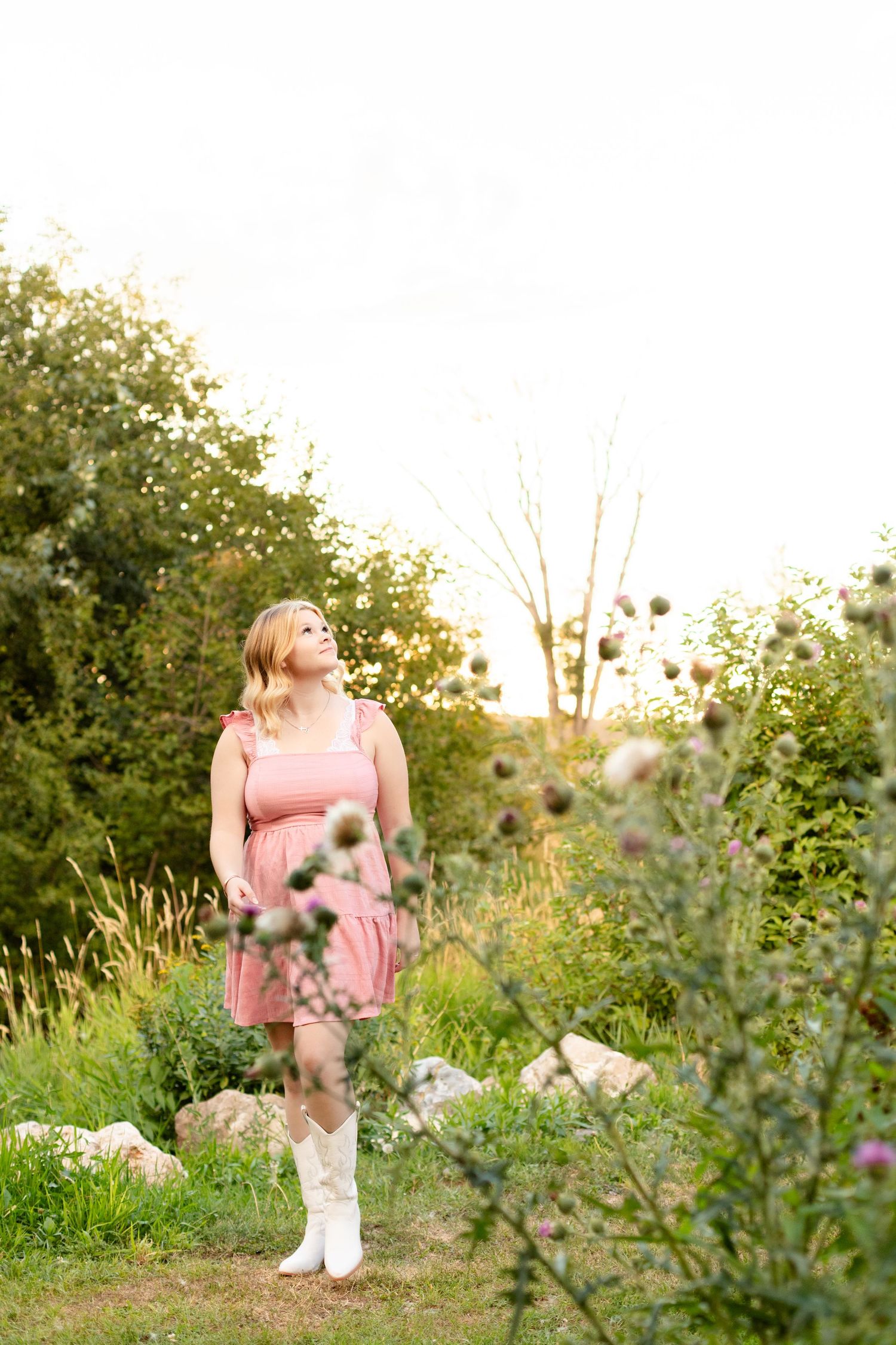 A dreamy outdoor portrait session among wildflowers and greenery at sunset.