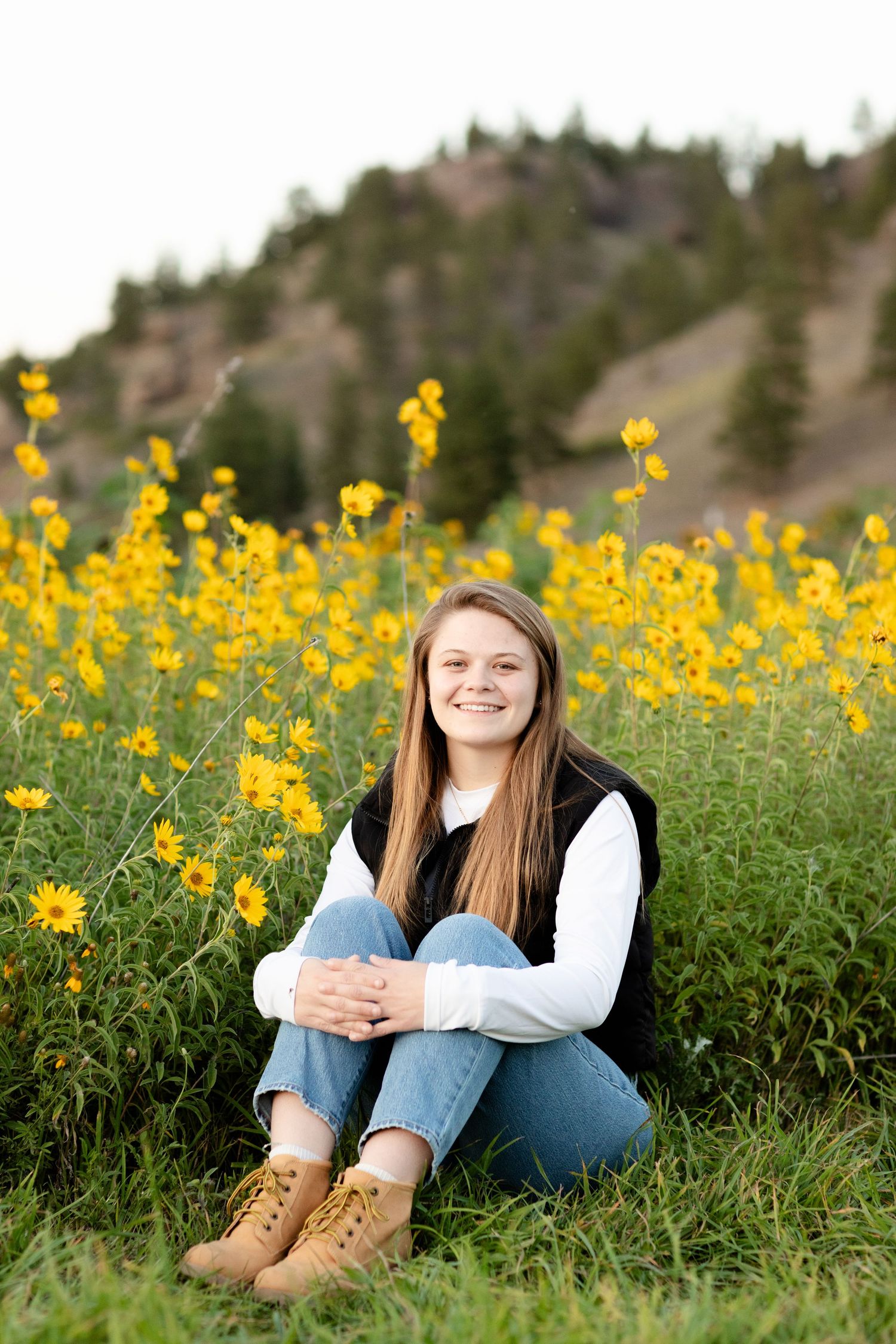 A series of outdoor portraits in a field of bright yellow wildflowers against a hillside backdrop.