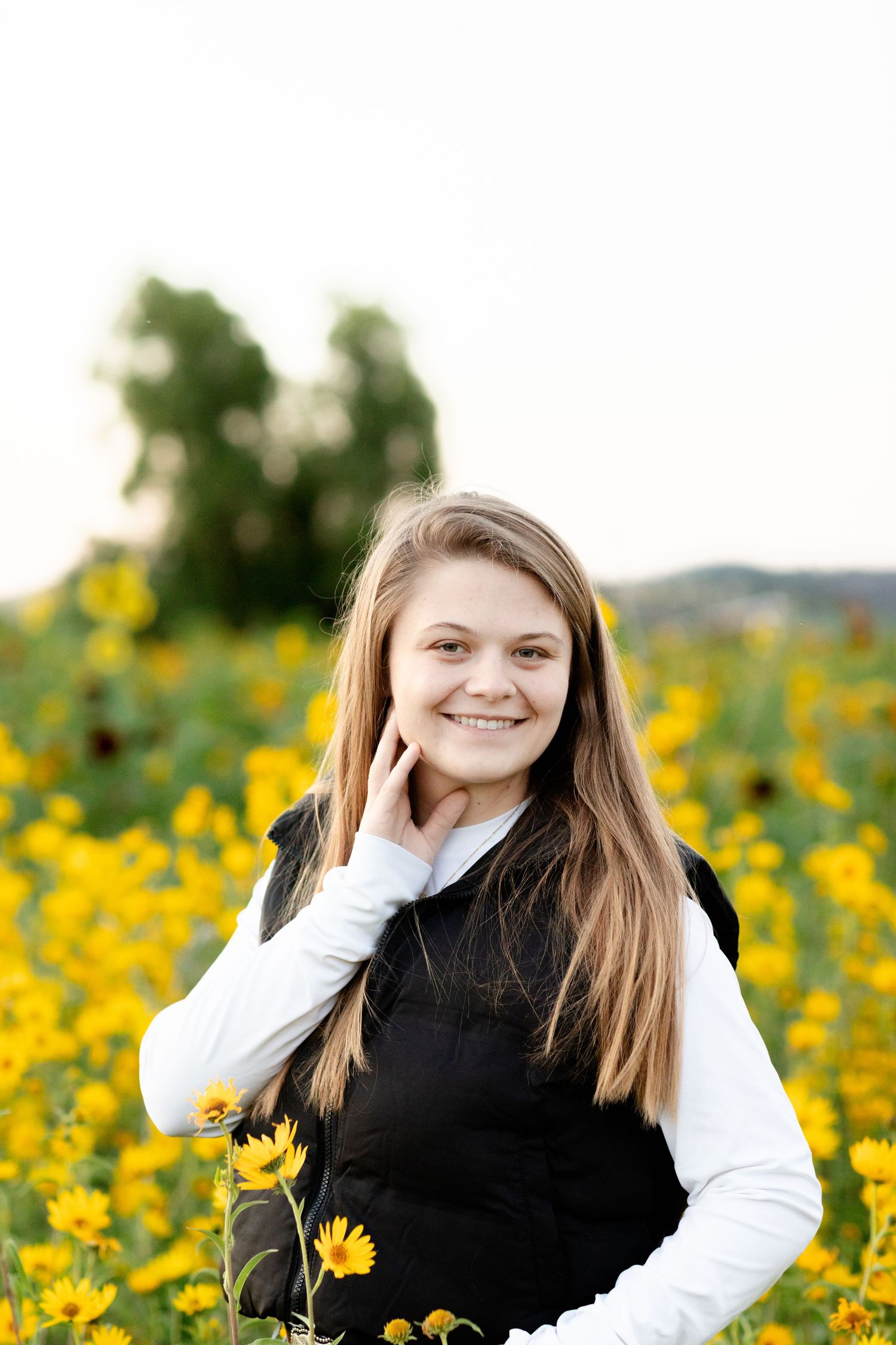 A series of outdoor portraits taken in a field of bright yellow wildflowers on a sunny day.