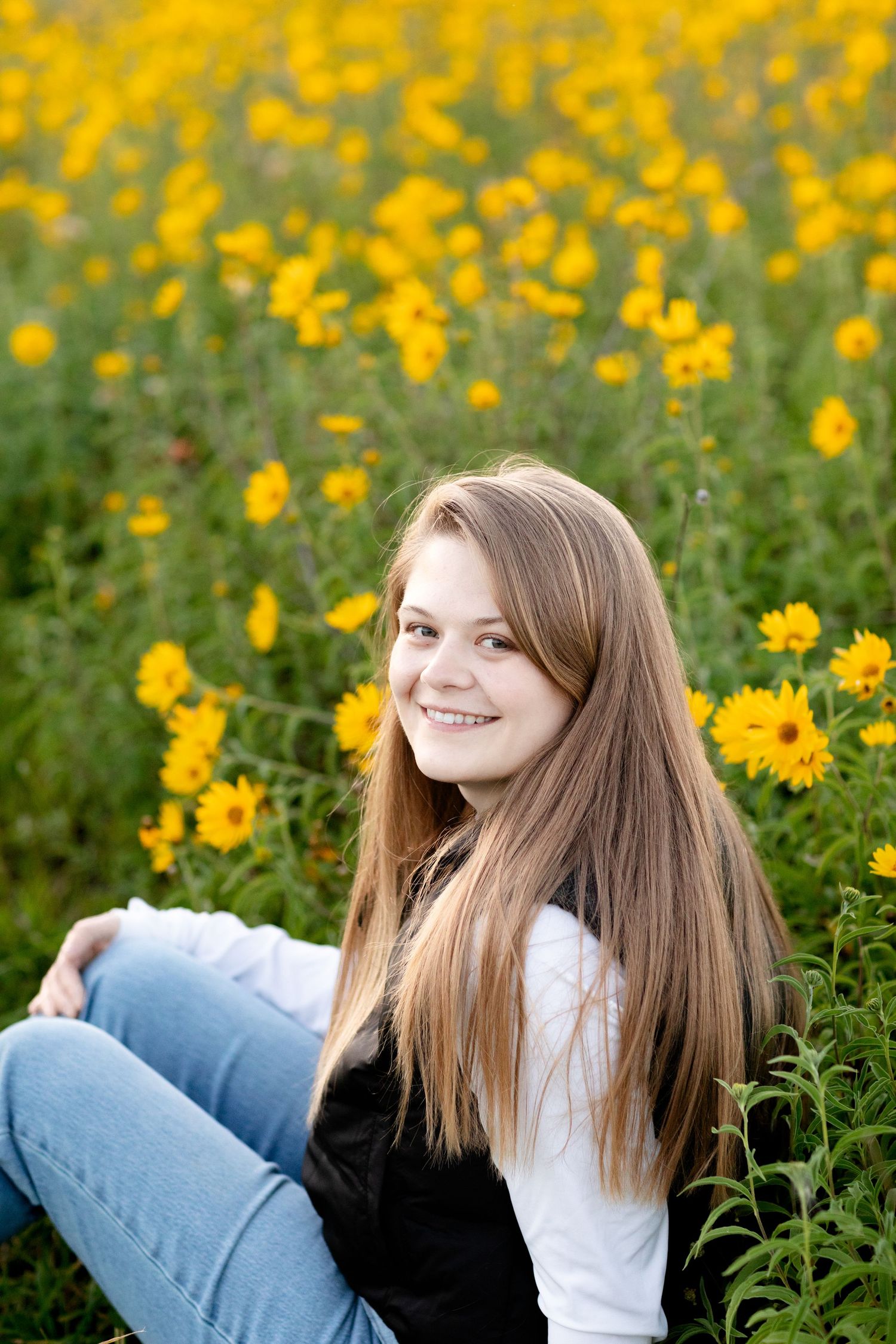 A joyful portrait session among vibrant yellow wildflowers on a sunny day.