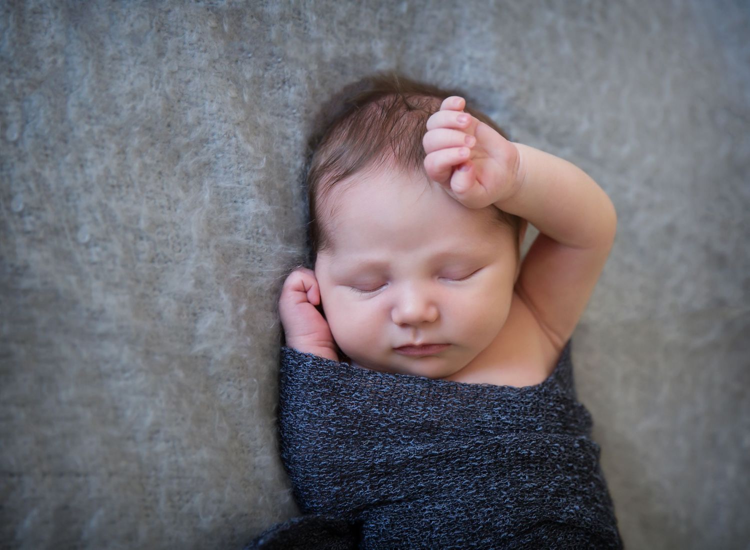 Newborn baby sleeping with arm above head. In-home newborn photoshoot in Adelaide SA.