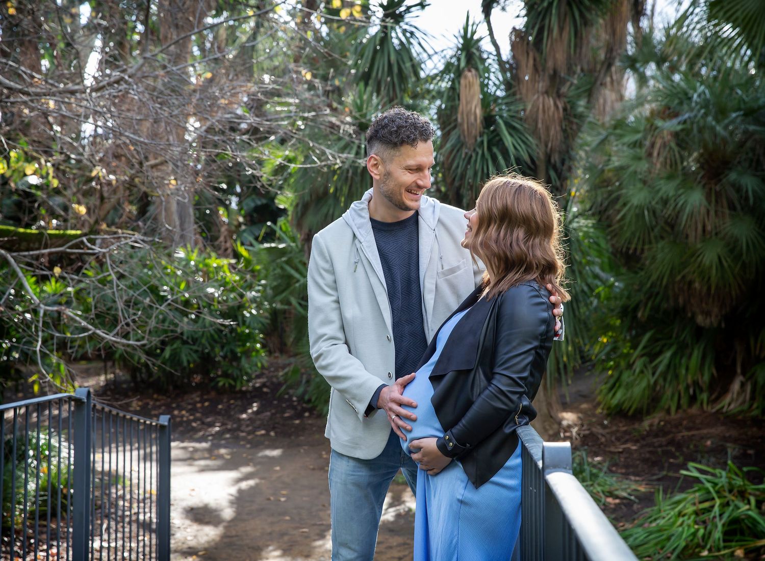 Husband doting over pregnant wife. Romantic maternity photography in Adelaide Botanic Gardens.