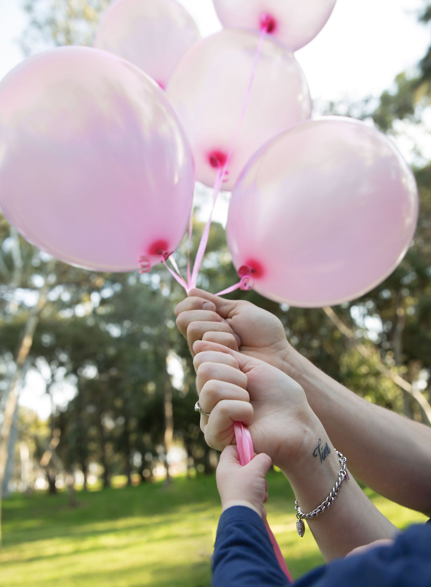 Pink balloons gender reveal announcement photoshoot in The Paddocks Reserve Adelaide SA.