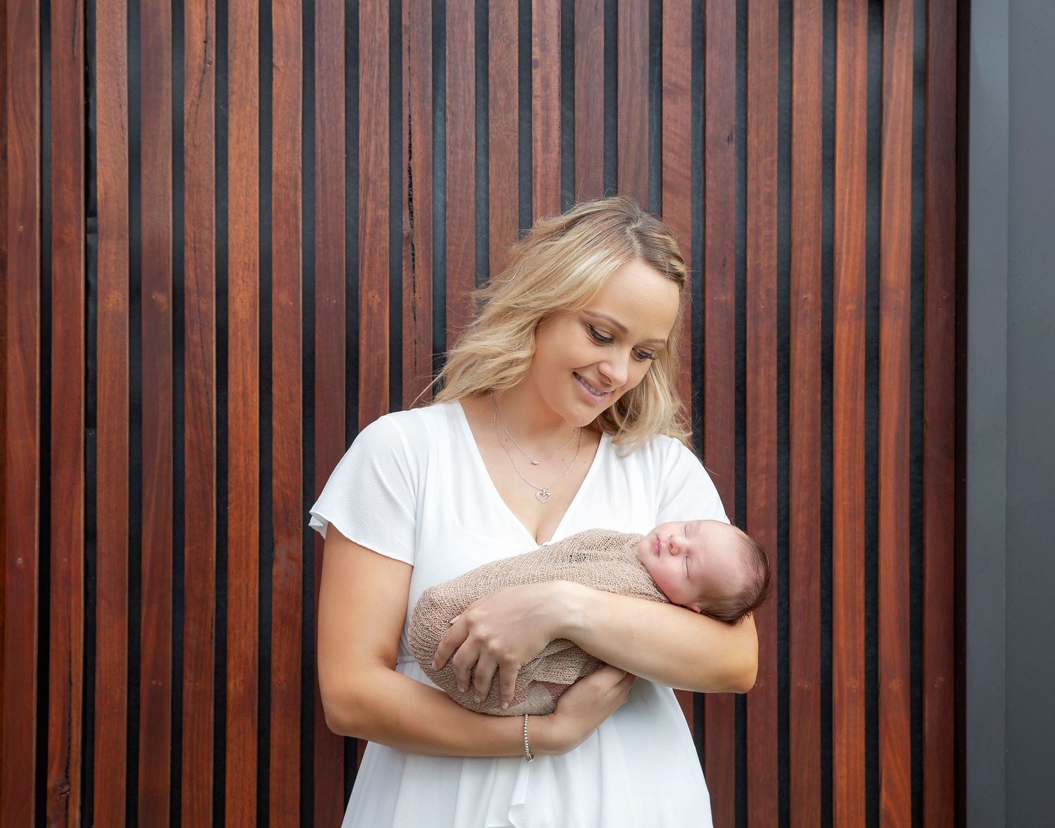 Candid moment of mum and dad looking at baby during Adelaide family newborn shoot
