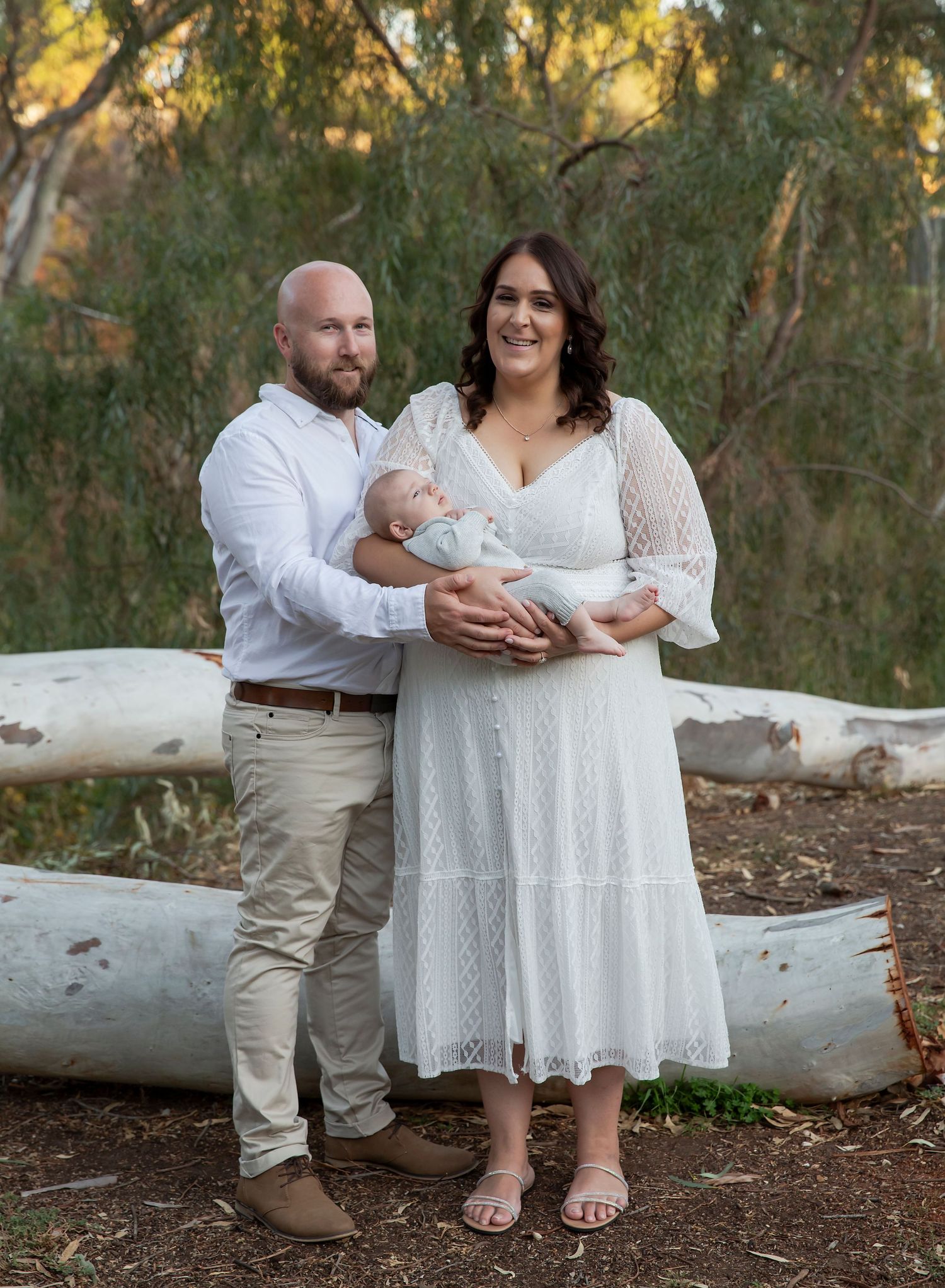 Young married couple in Clonlea Park Gawler SA with their sleeping newborn baby in newborn photoshoot.