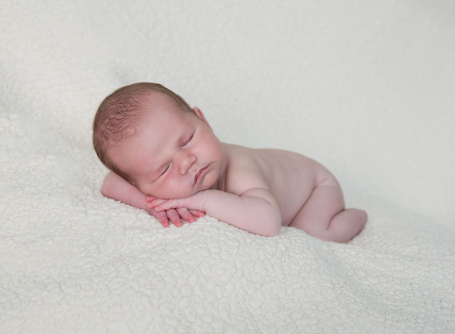 Hands under chin pose of newborn baby. In-home newborn photoshoot in Adelaide SA.