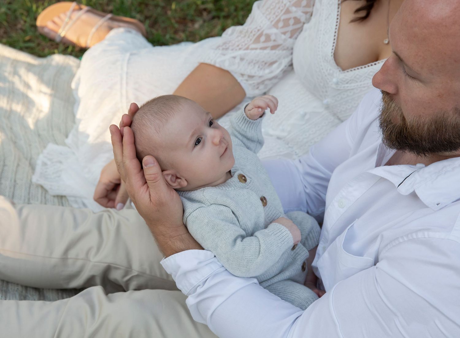 Newborn baby starring at dad, outdoor family newborn session, Gawler - Clonea park.