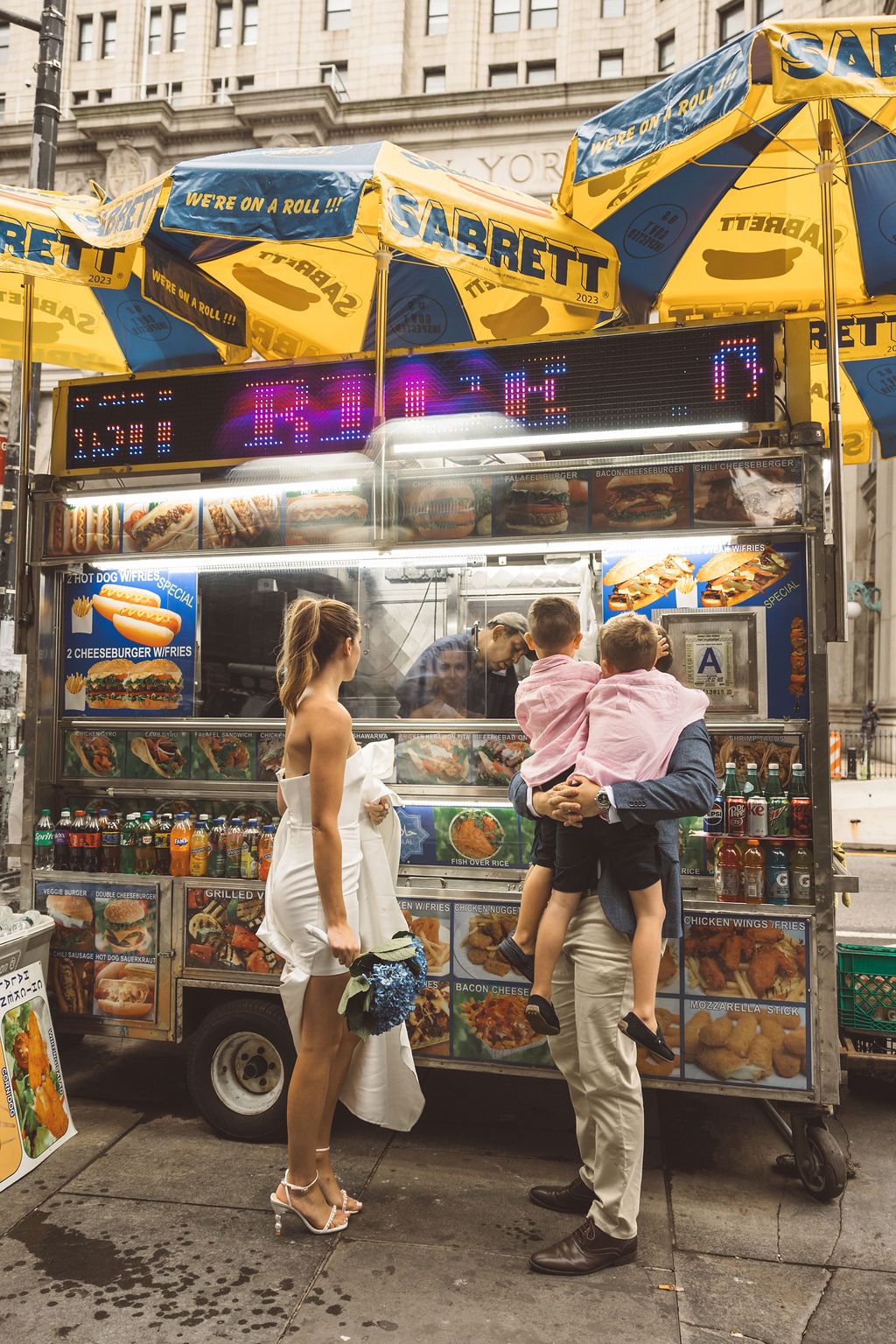 cute picture of the newlyweds and their kids walking around NYC