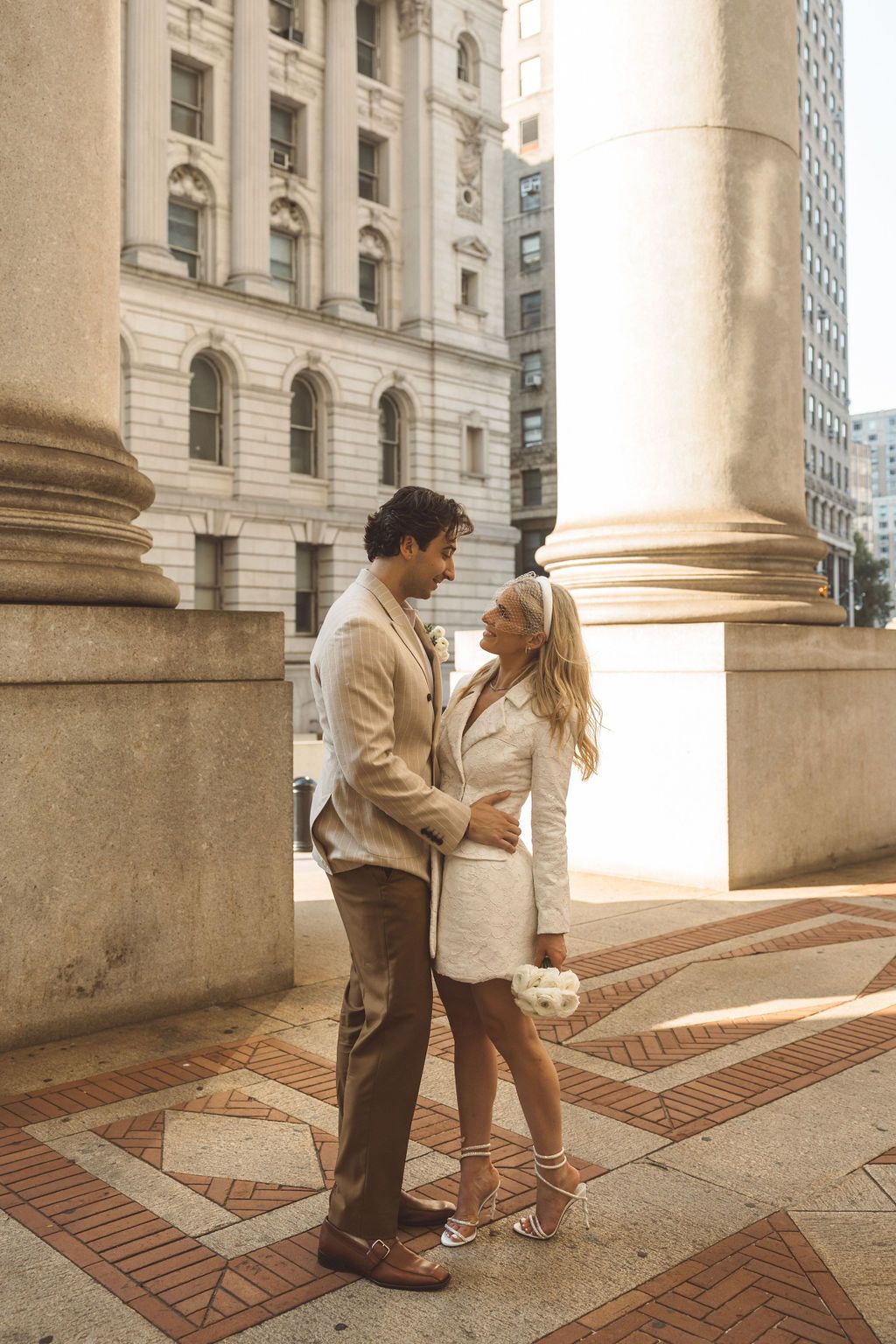 couple smiling at each other during their session