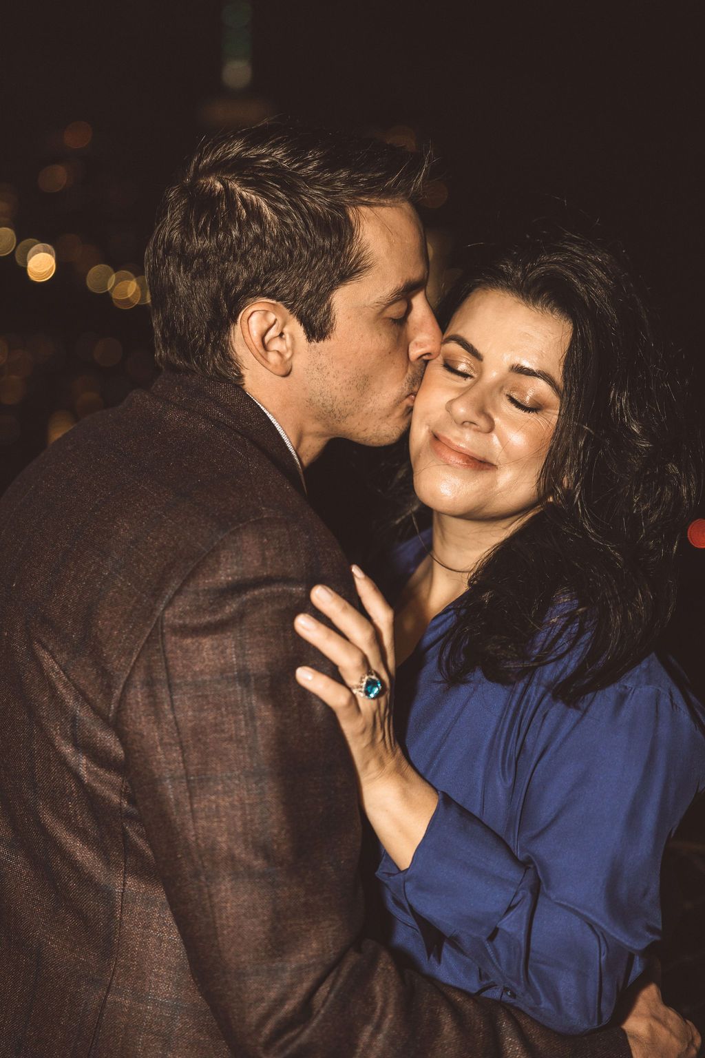 fiance kissing his fiance on the cheek