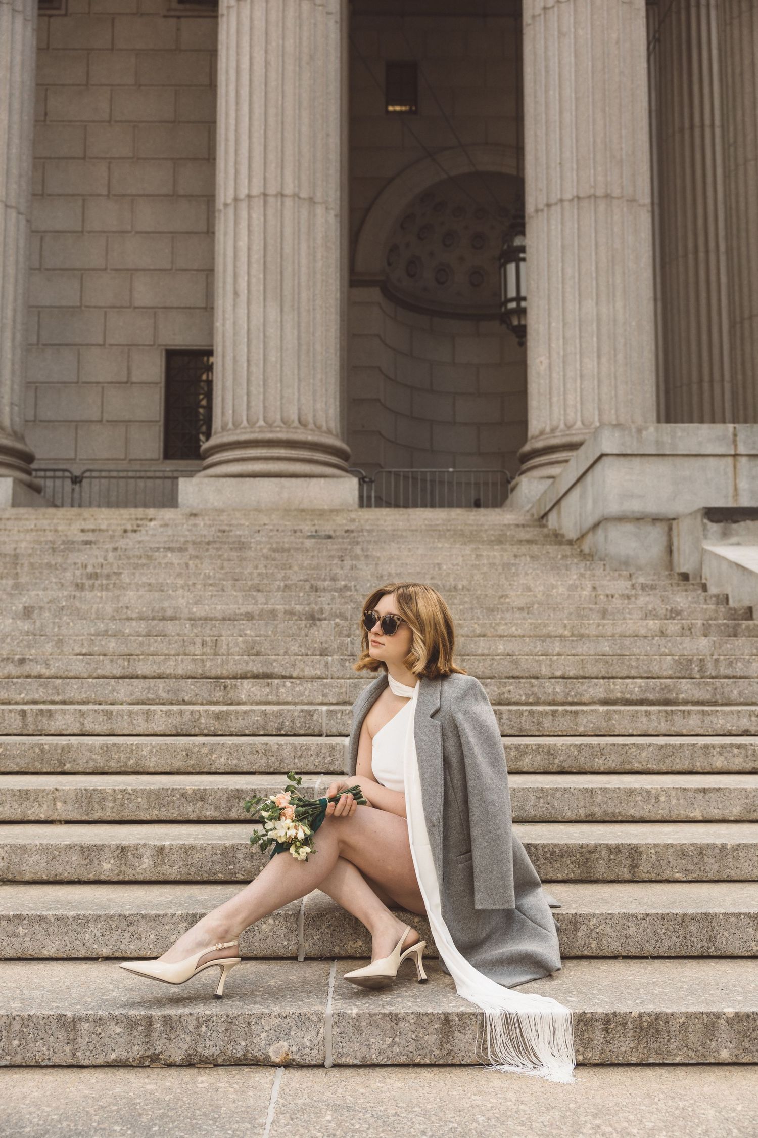 Editorial bridal portrait on the steps of Manhattan City Hall after civil ceremony