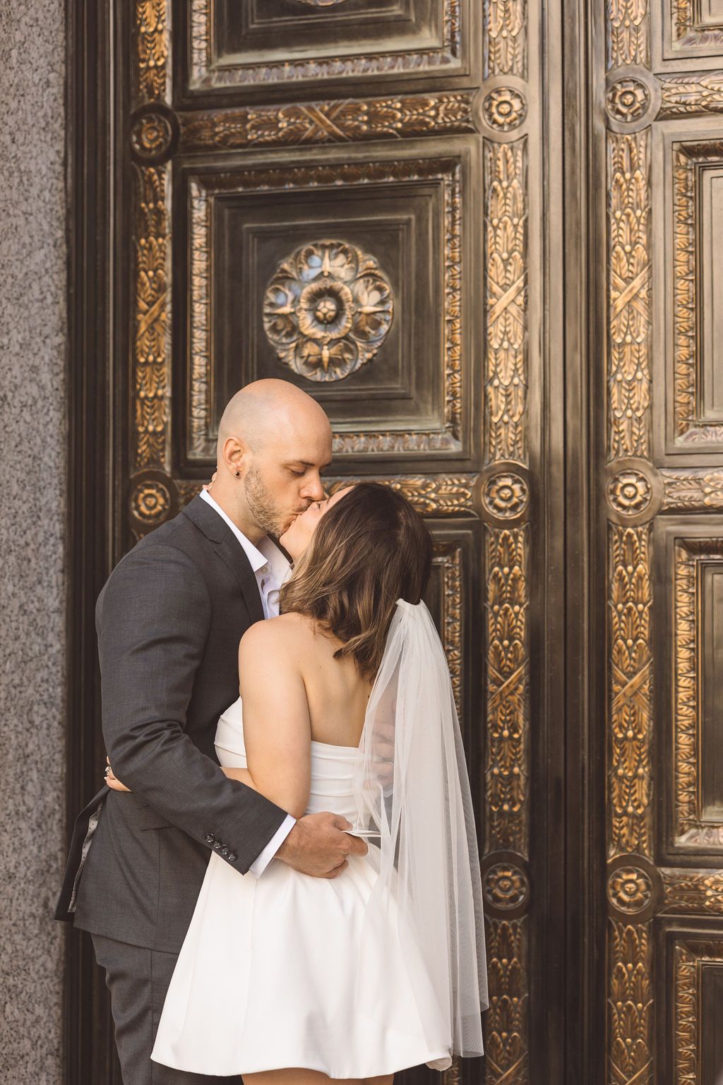 cute picture of the newlyweds kissing during their photoshoot