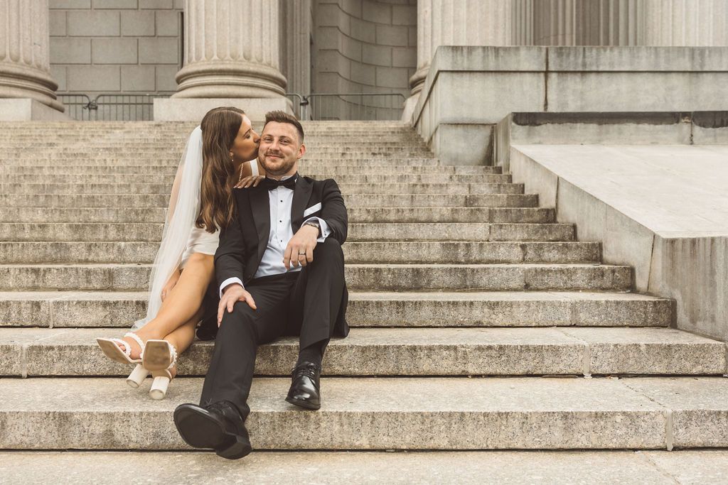 bride kissing the groom on the cheek