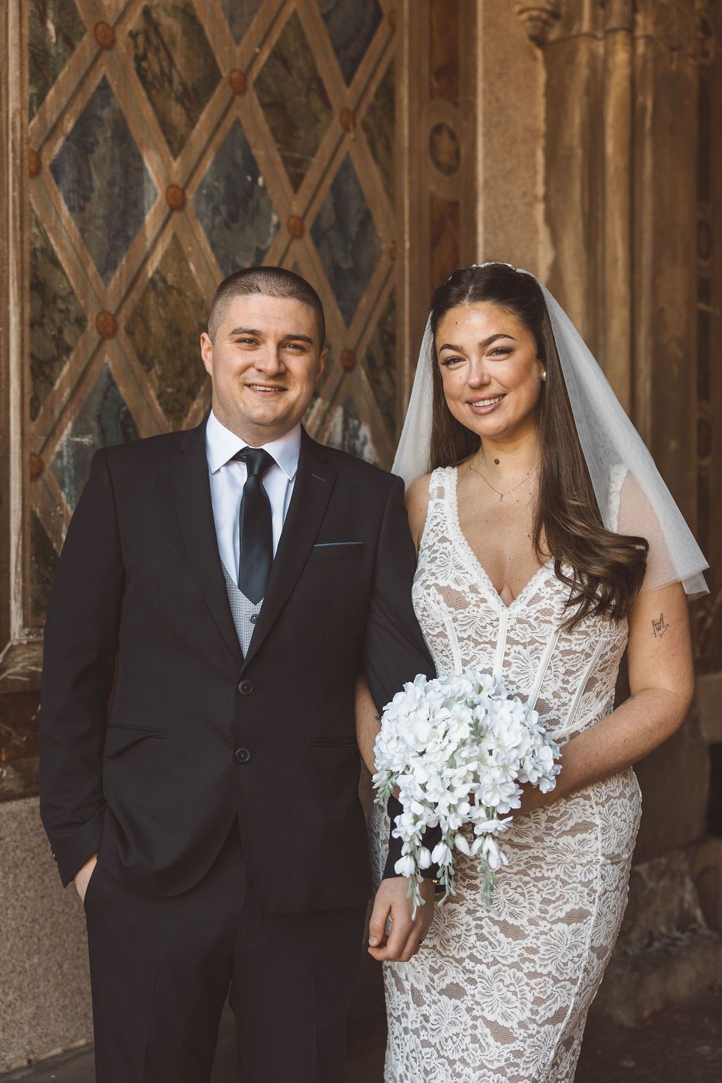 cute picture of the newlyweds smiling at the camera during their bridal photos
