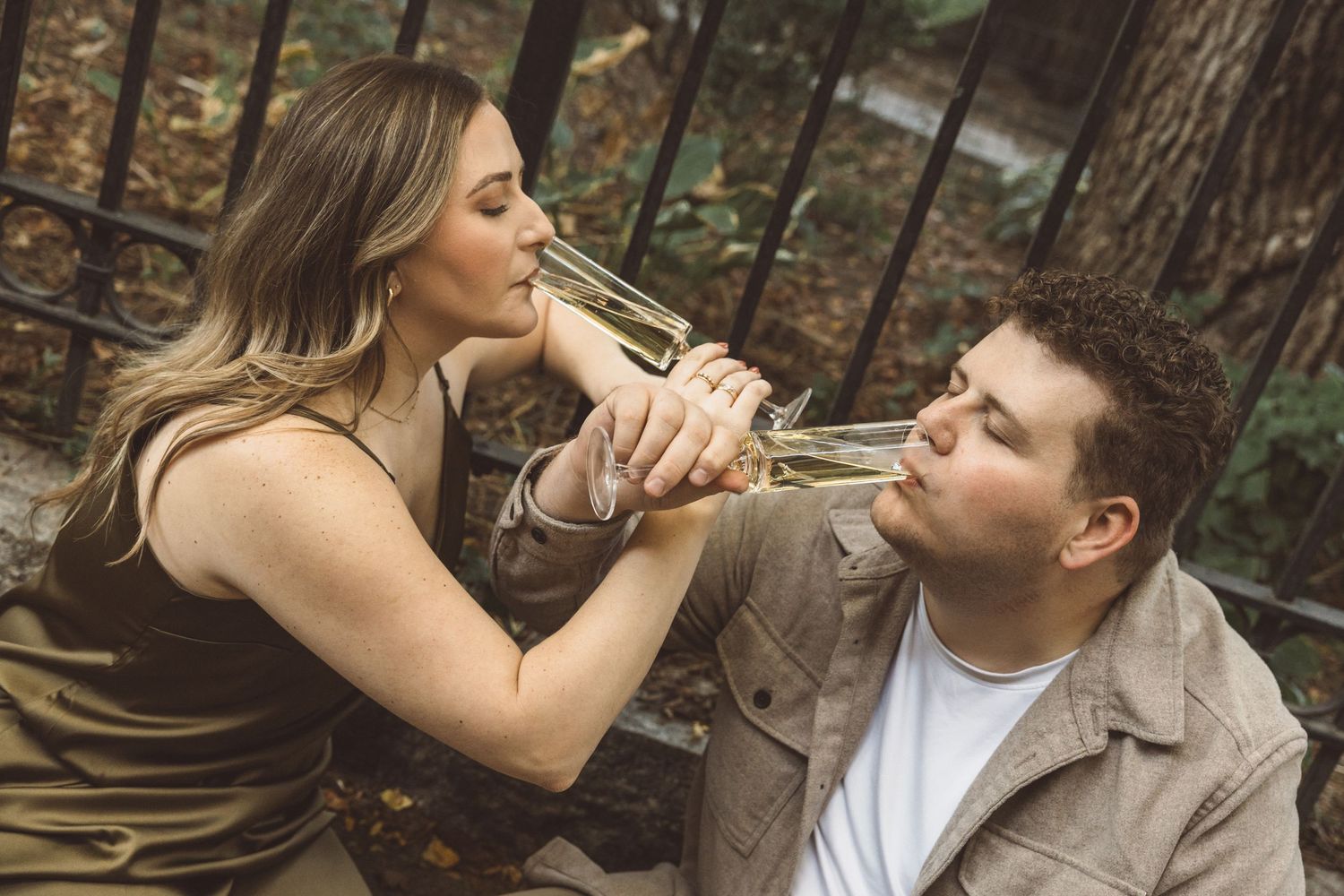couple celebrating their engagement with champagne