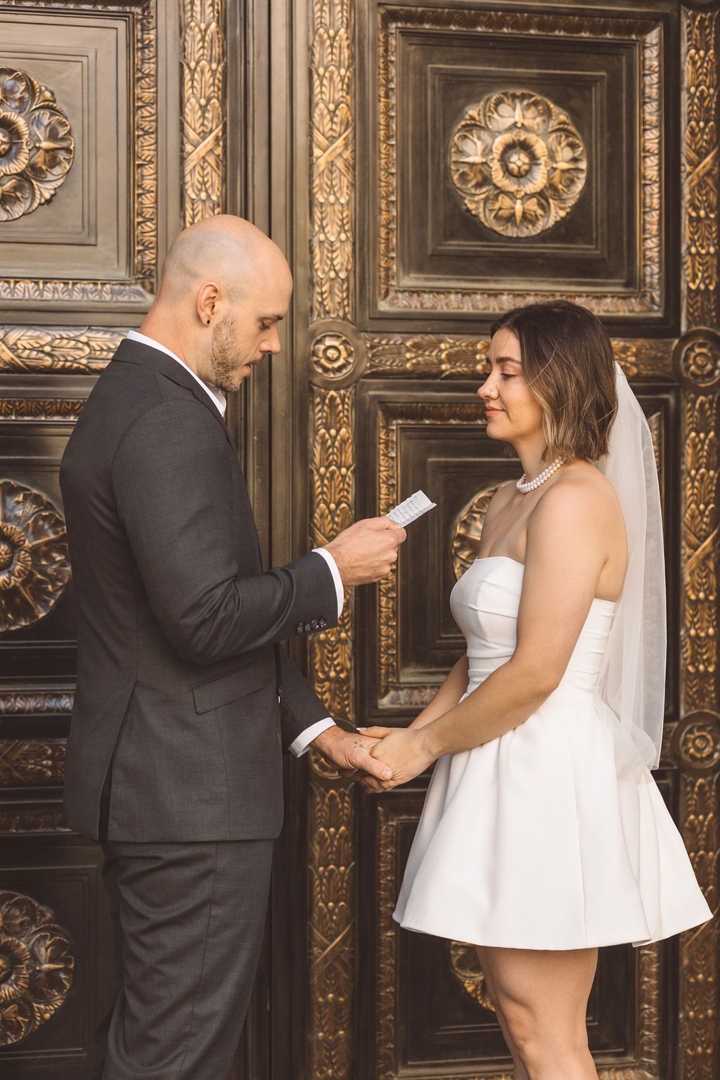 cute picture of the newlyweds reading their private vows