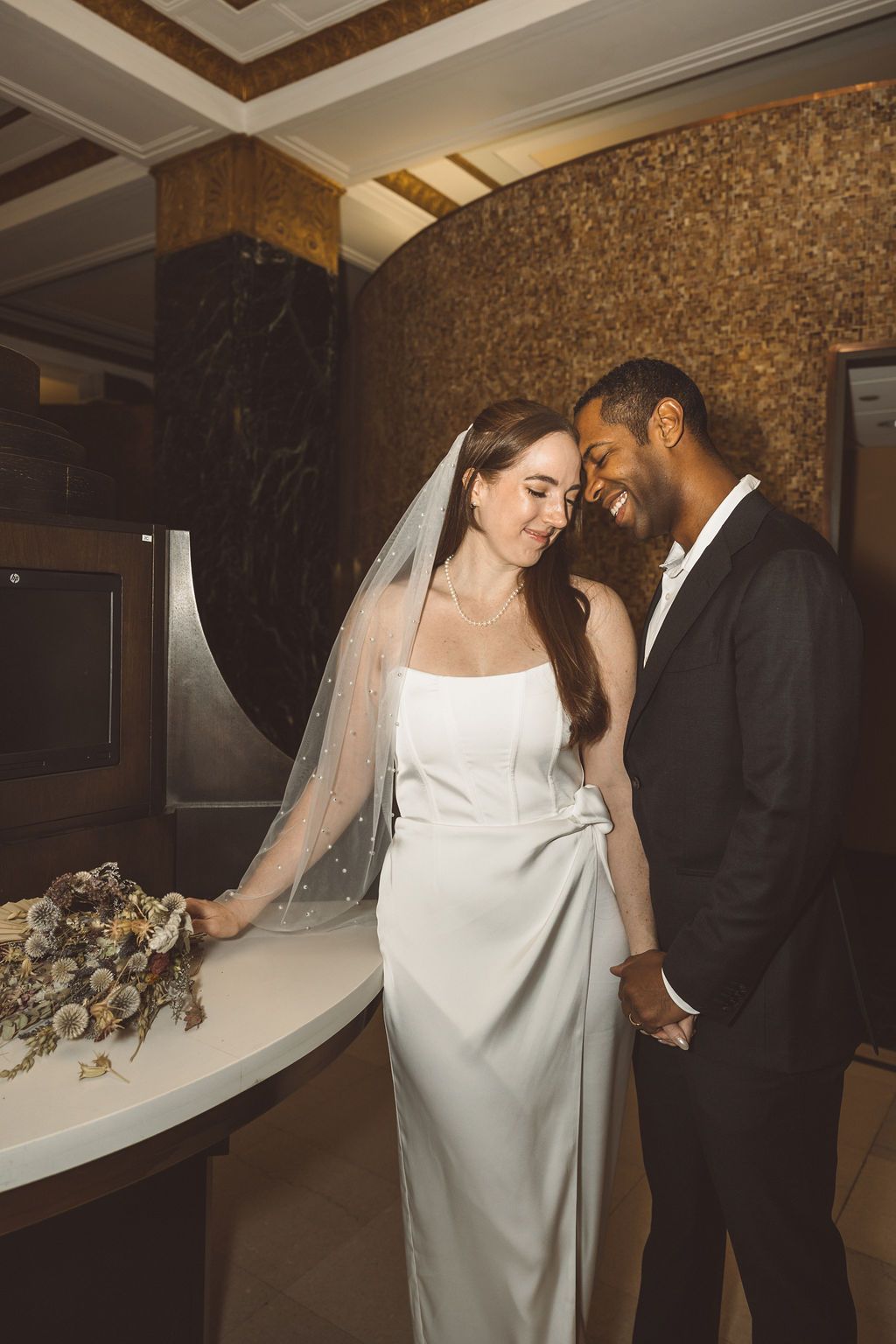 groom kissing the bride on the forehead
