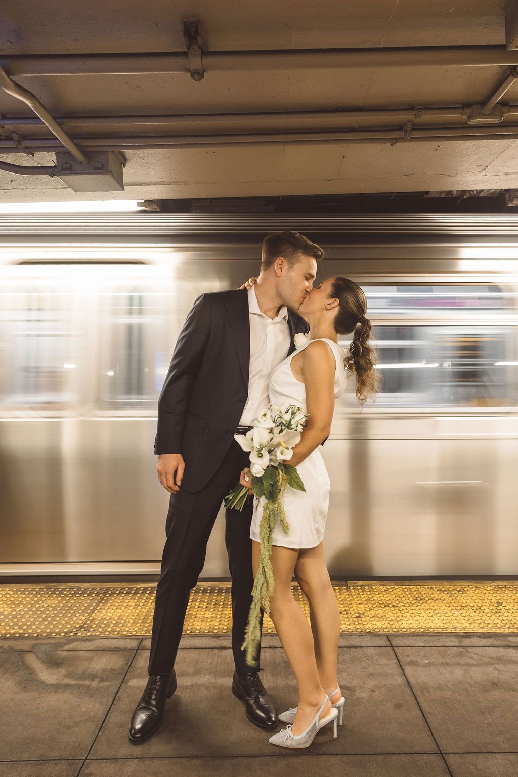 portrait of the newlyweds kissing