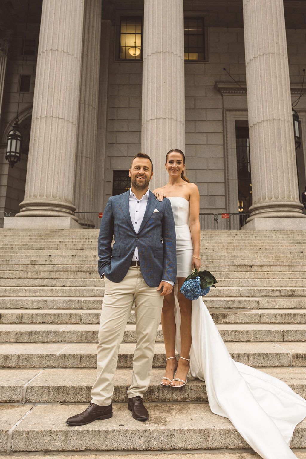 Cute picture of the newly married couple smiling at the camera