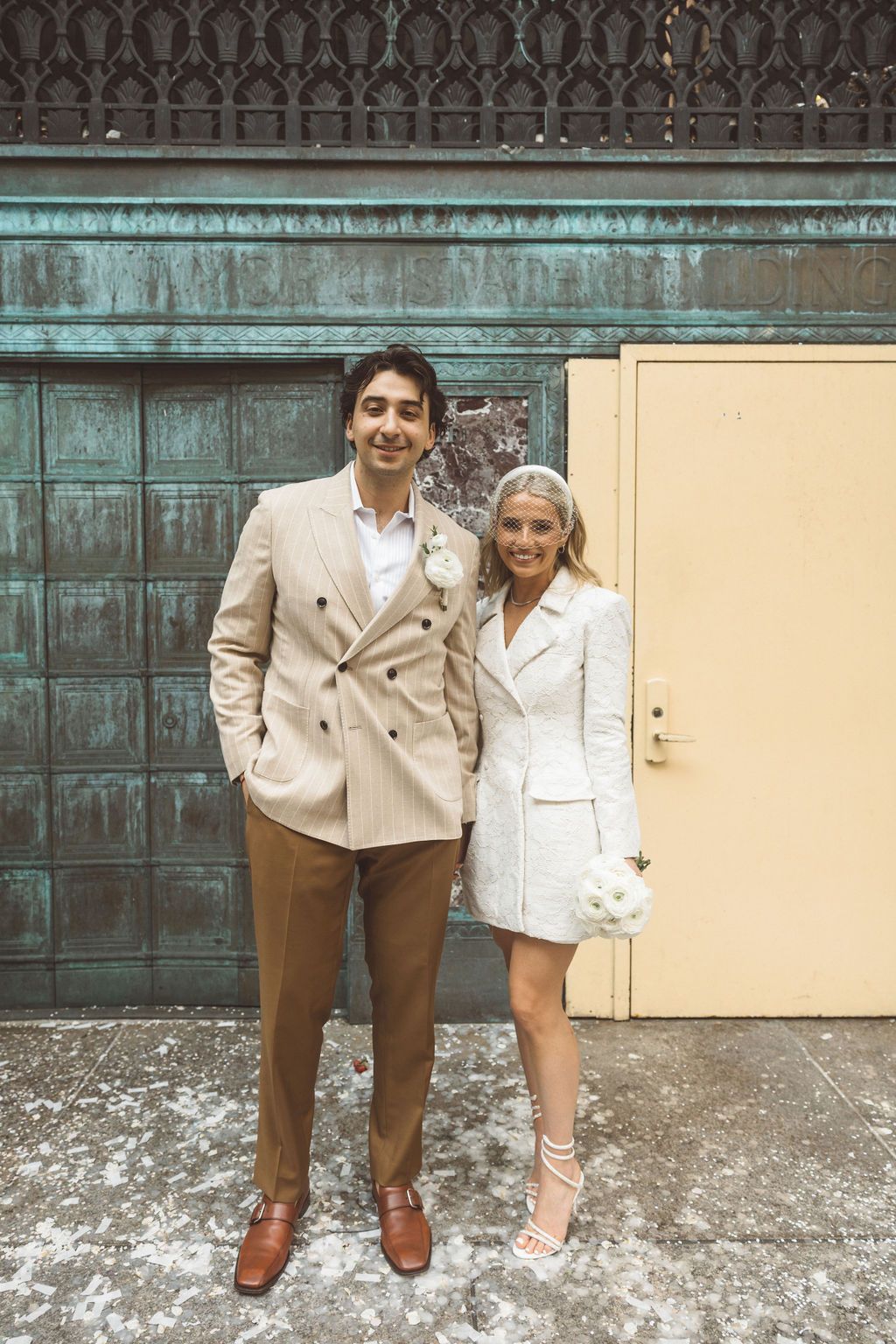 newlyweds smiling at the camera during their photoshoot