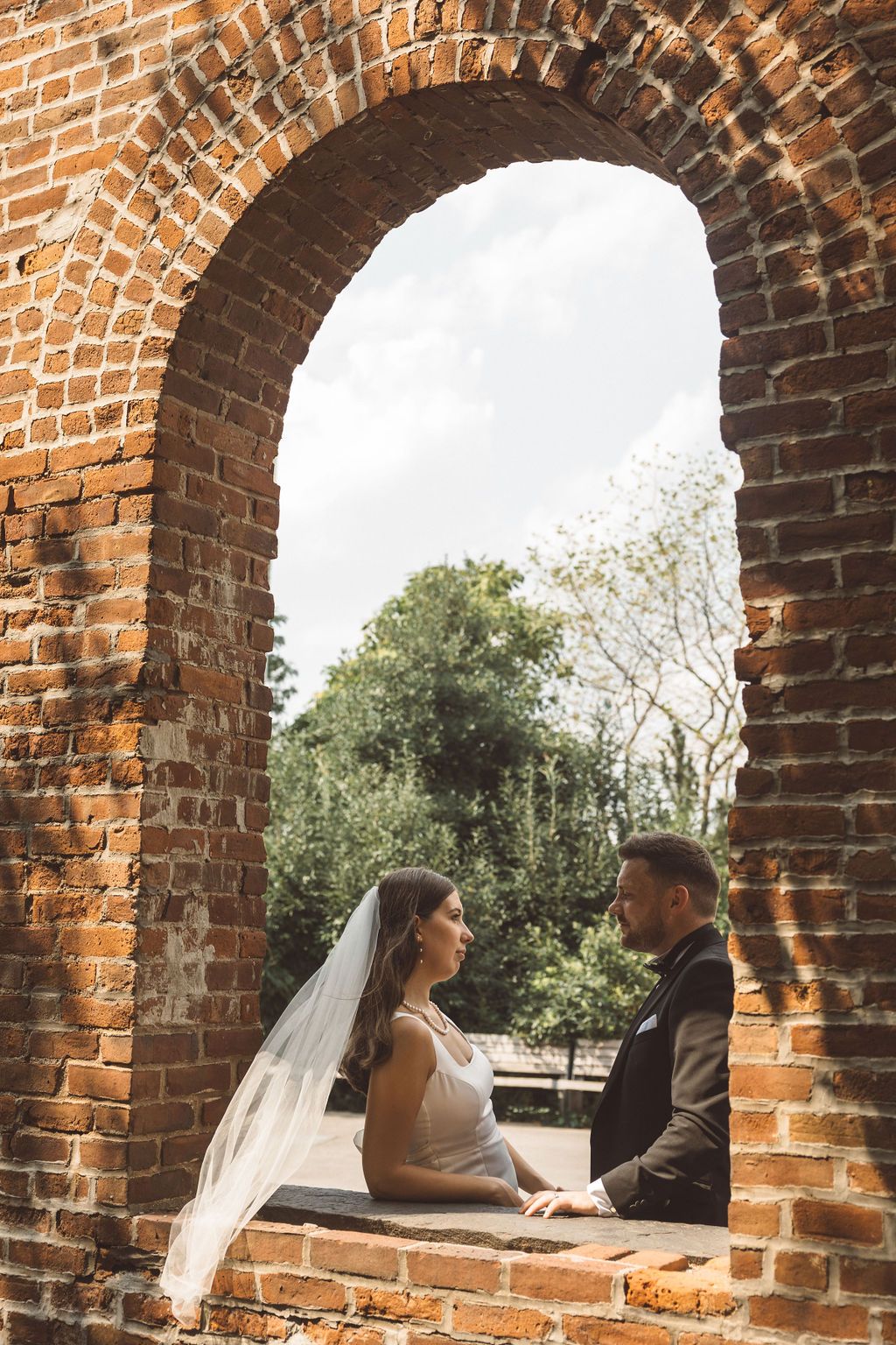 couple smiling at each other during their session