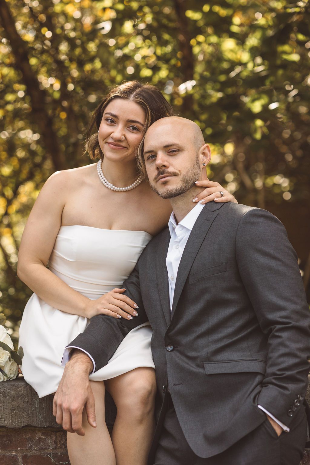 cute picture of the couple smiling at the camera during their photoshoot