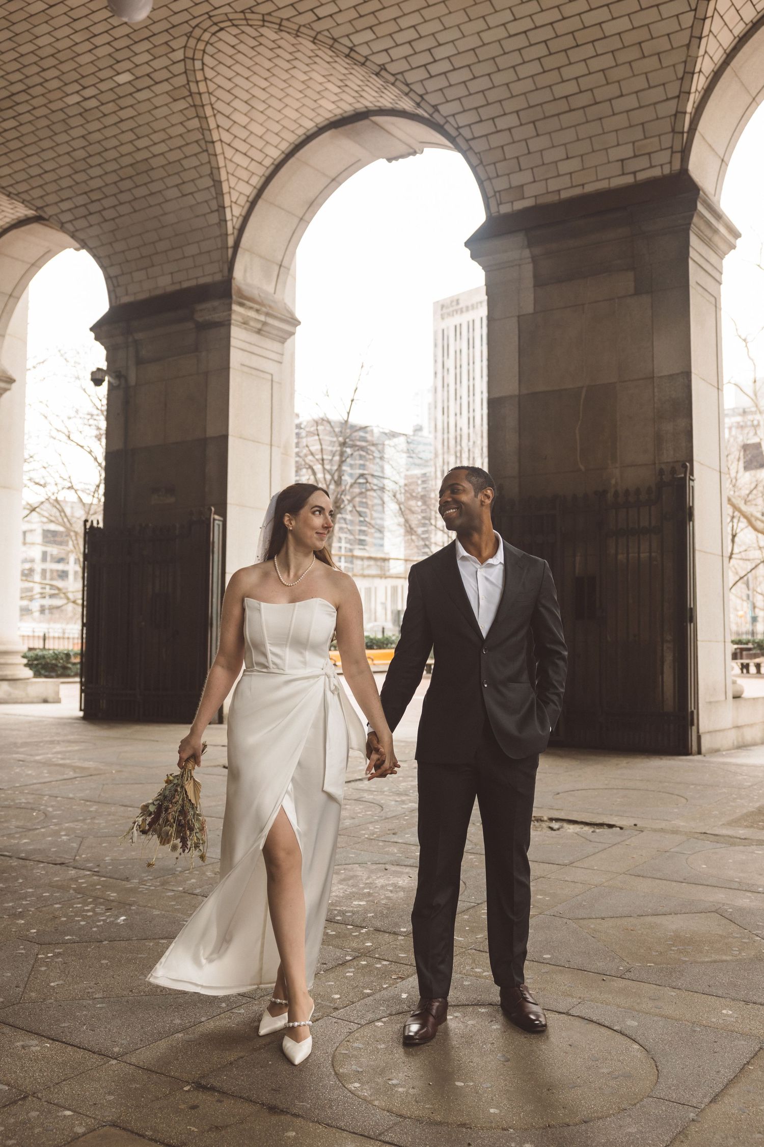 Portrait of the newly married couple holding hands during their bridal photos