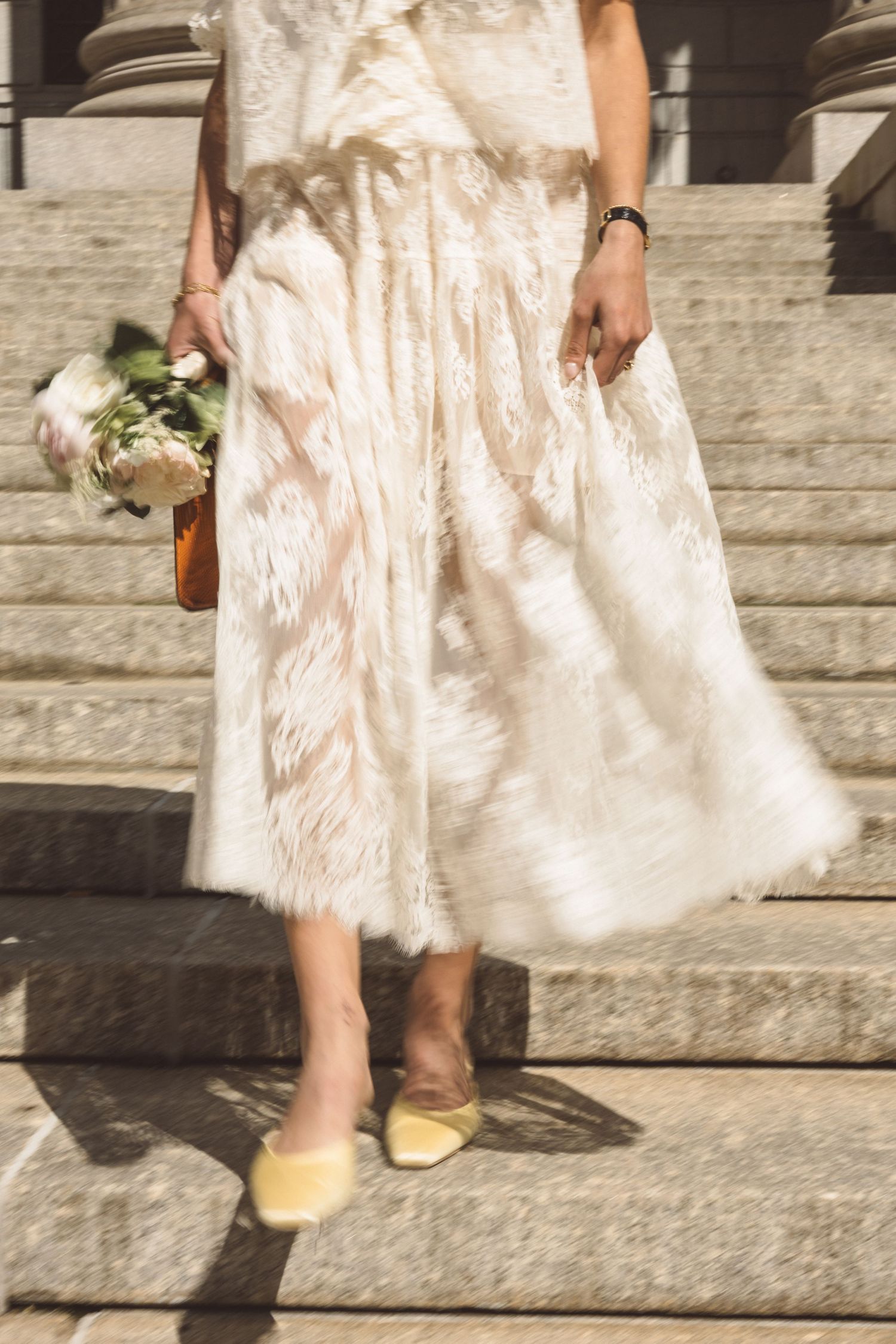 closeup shot of the brides dress and bouquet