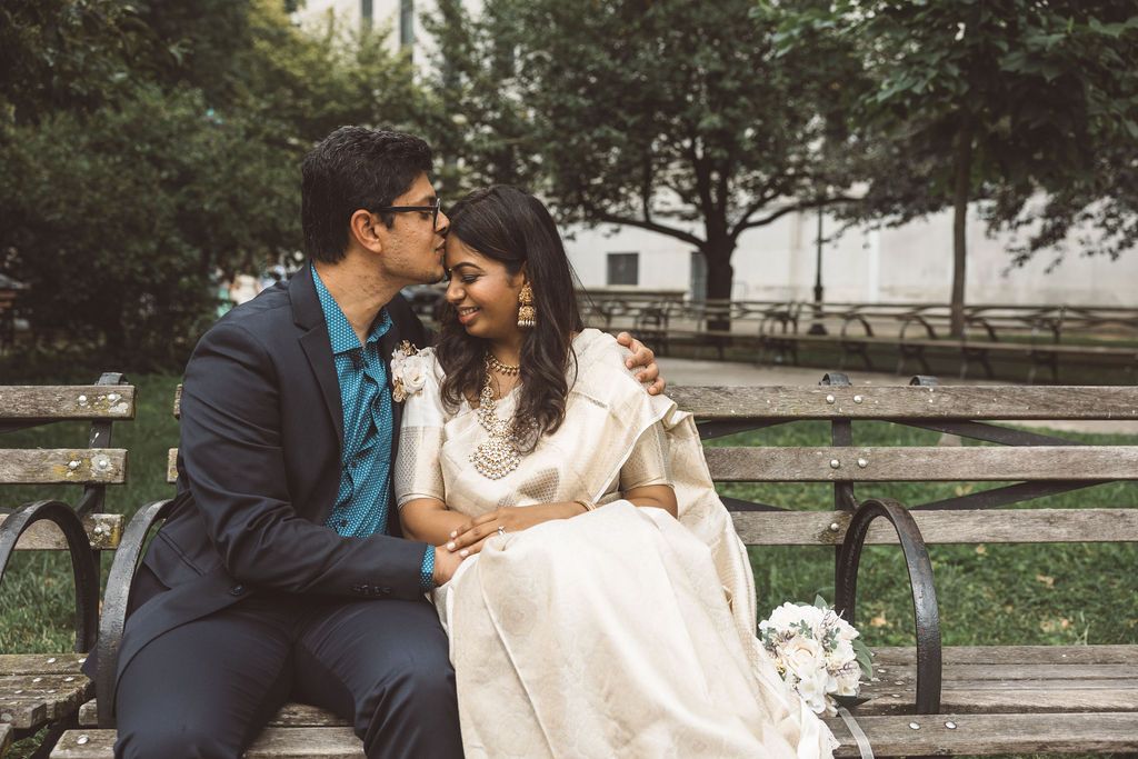 groom kissing the bride on the forehead