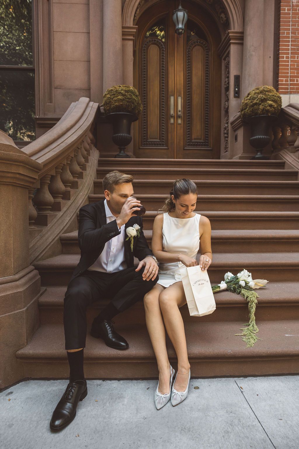 couple celebrating their elopement with pastries