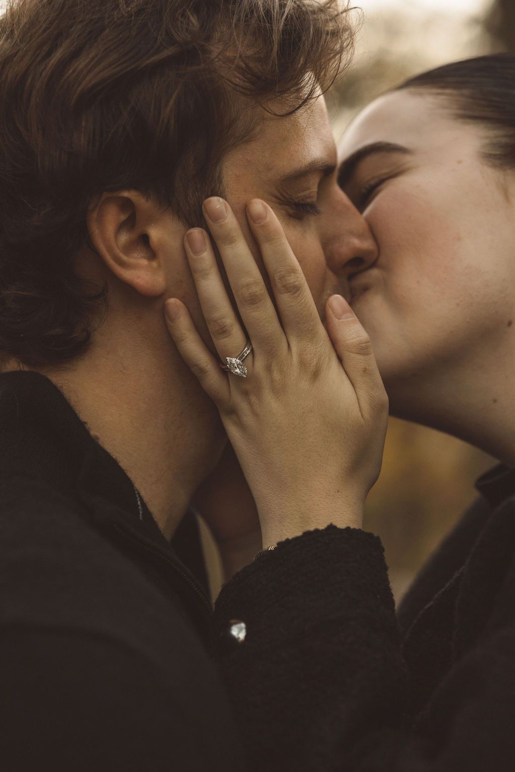 couple kissing during their fall engagement session