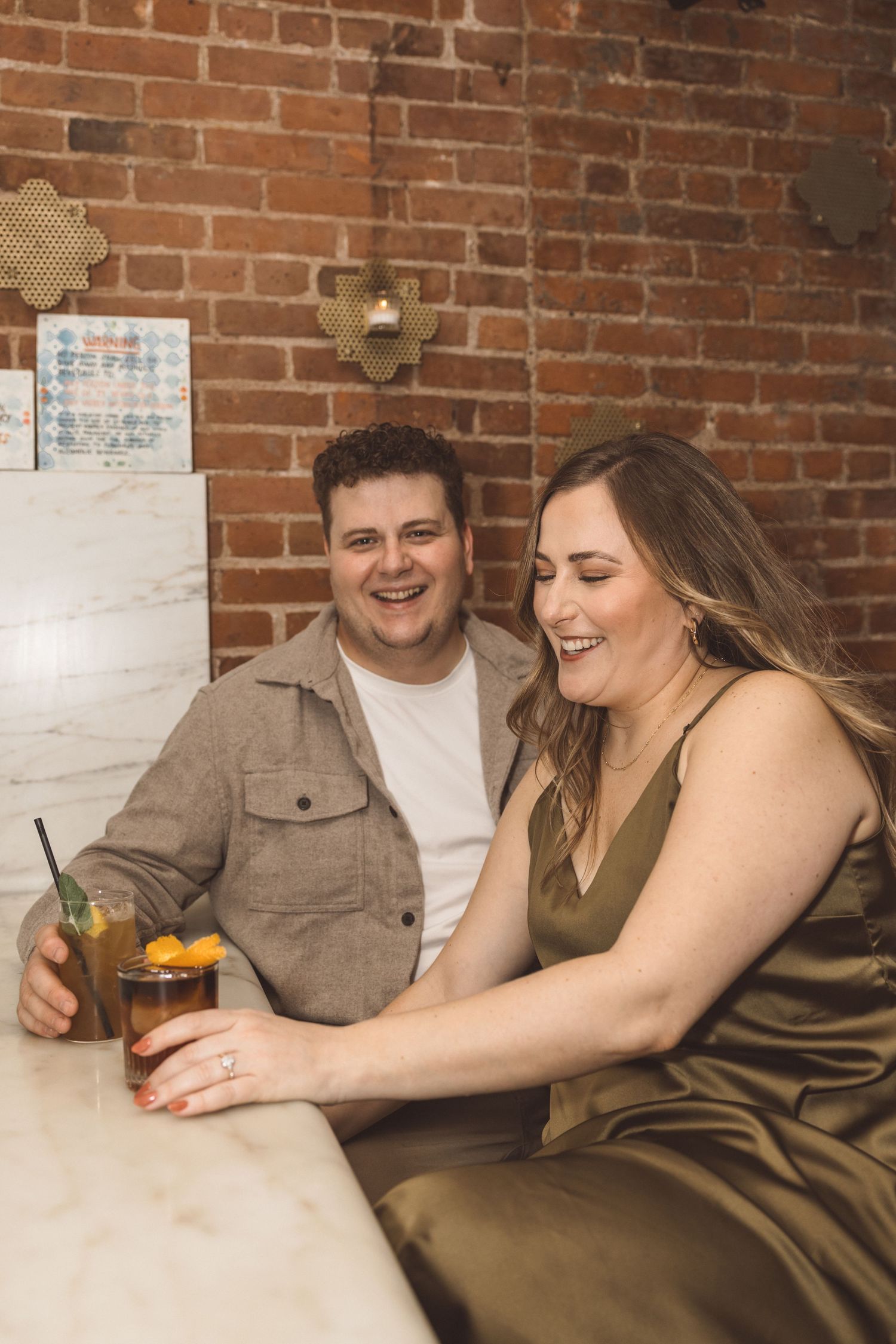 couple celebrating their engagement with drinks