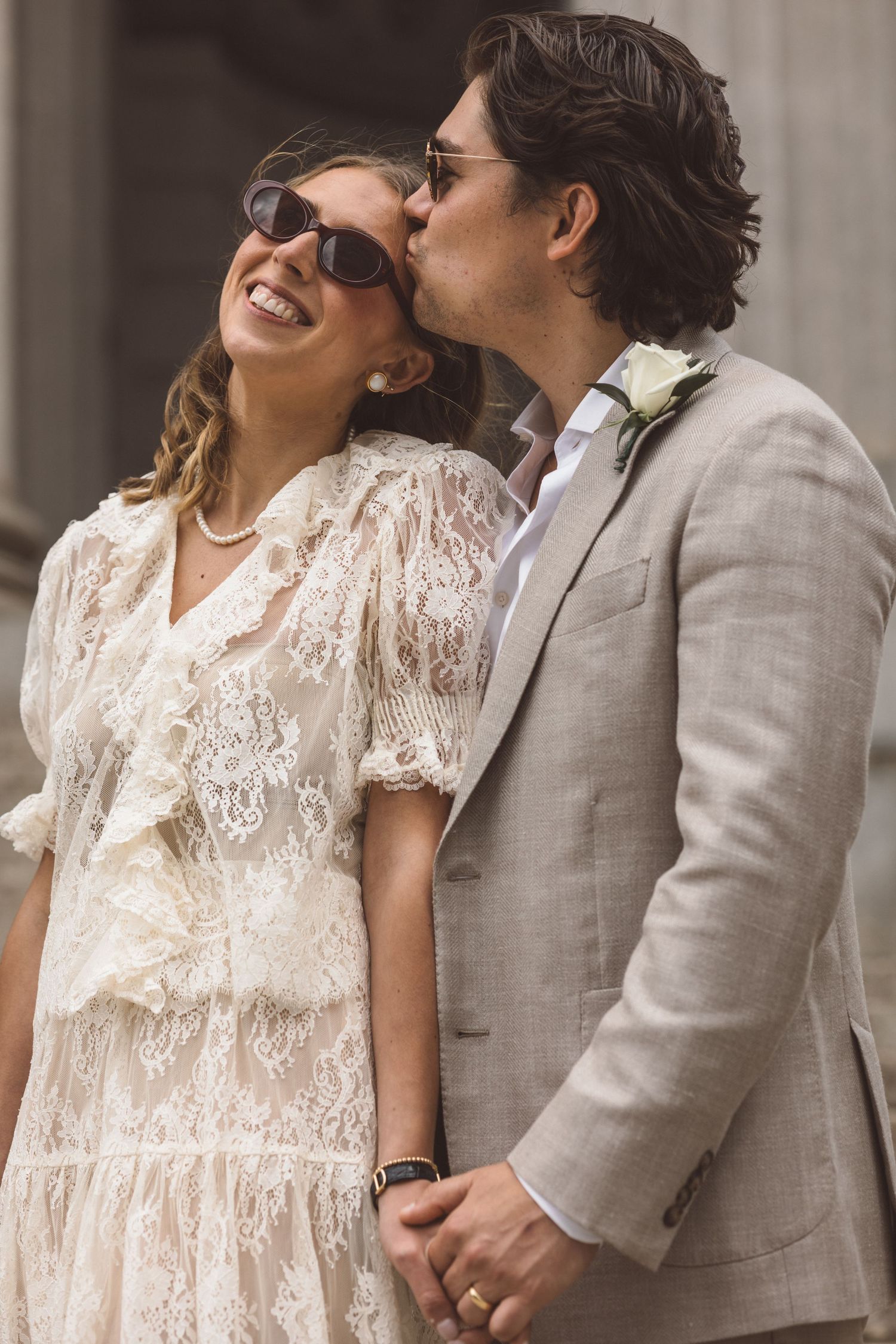 Beautiful picture of the groom, kissing the bride on the cheek