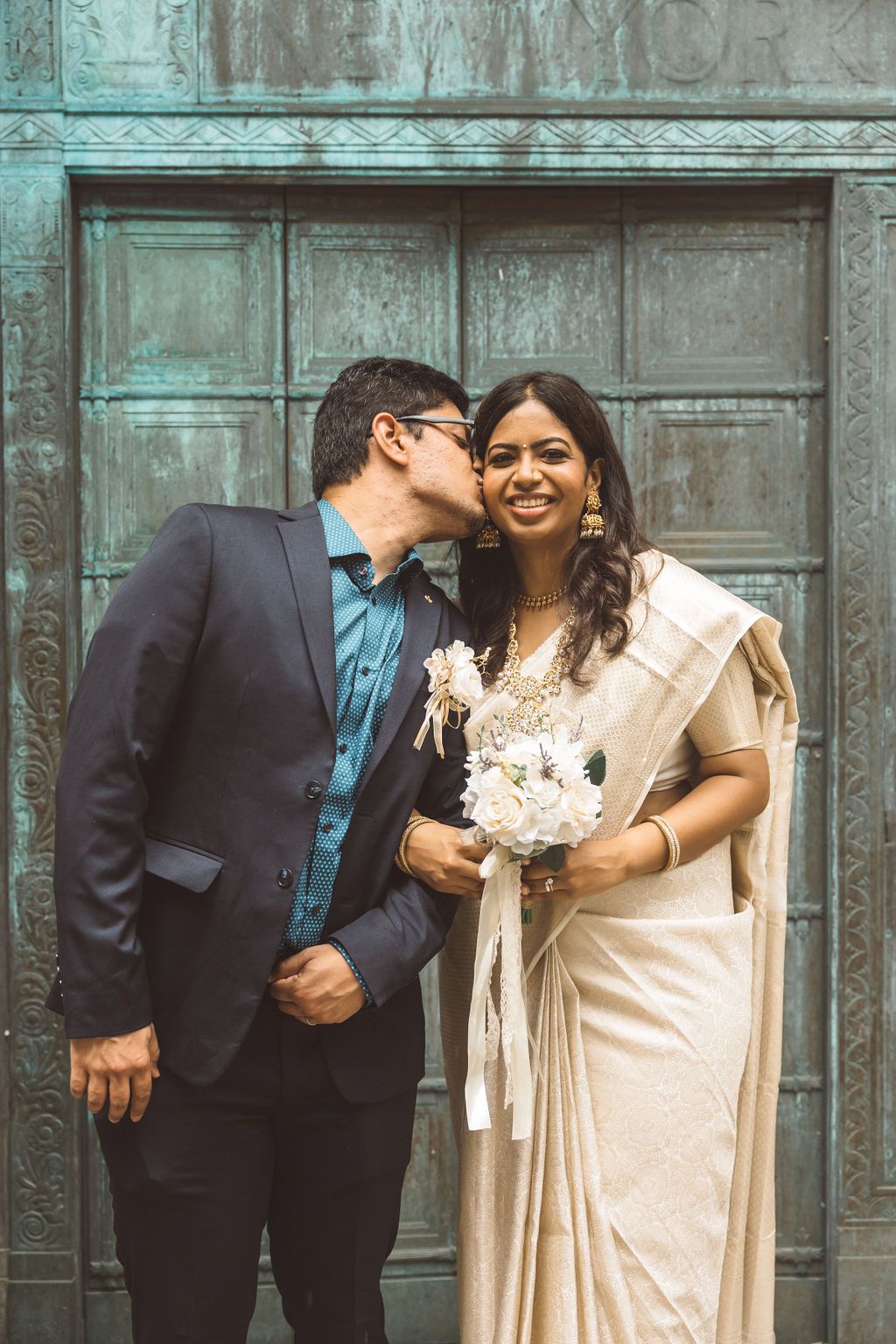 cute picture of the groom kissing the bride on the cheek