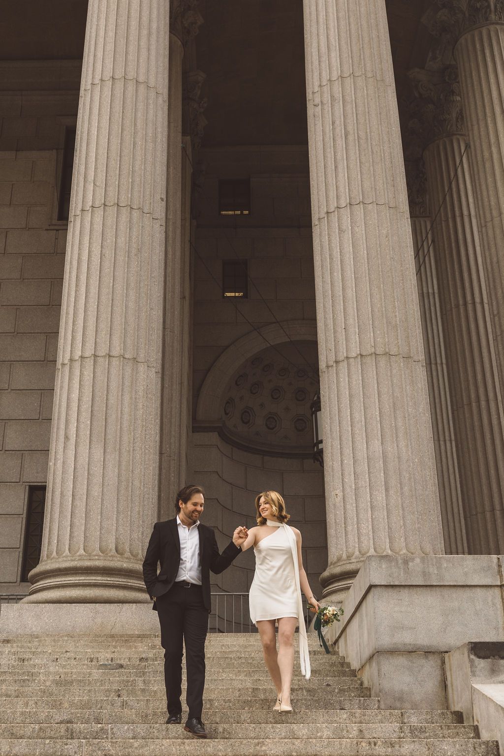 bride and groom smiling at each other