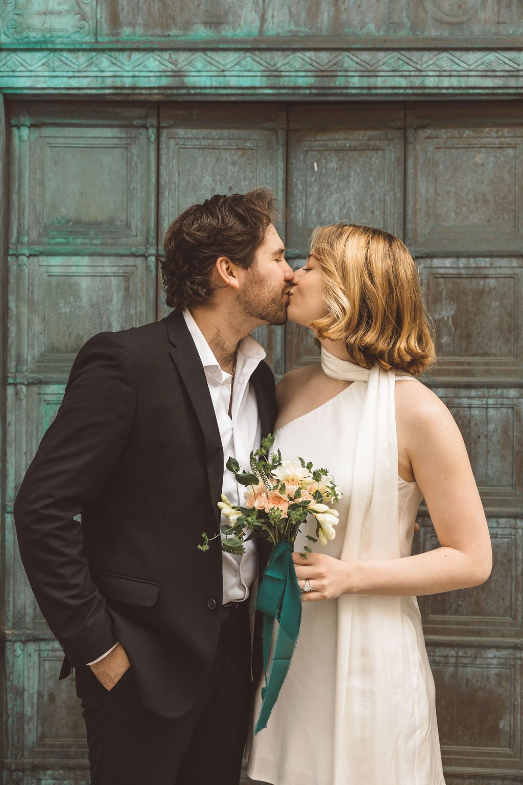 cute picture of the bride and groom kissing after their ceremony