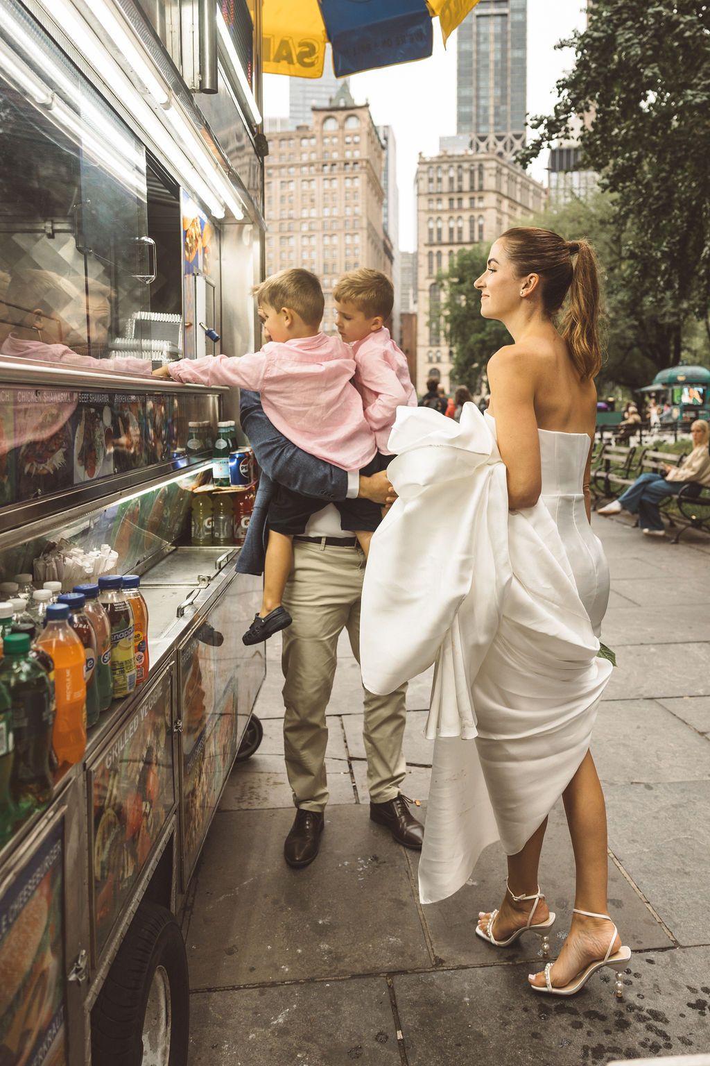 newlyweds celebrating their elopement with hot dogs ins NY